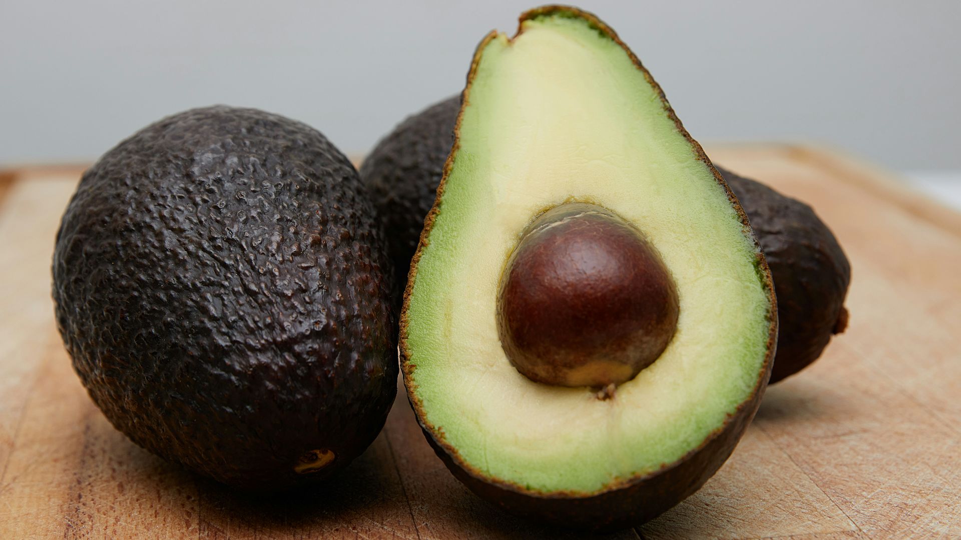 sliced avocado fruit on brown wooden table