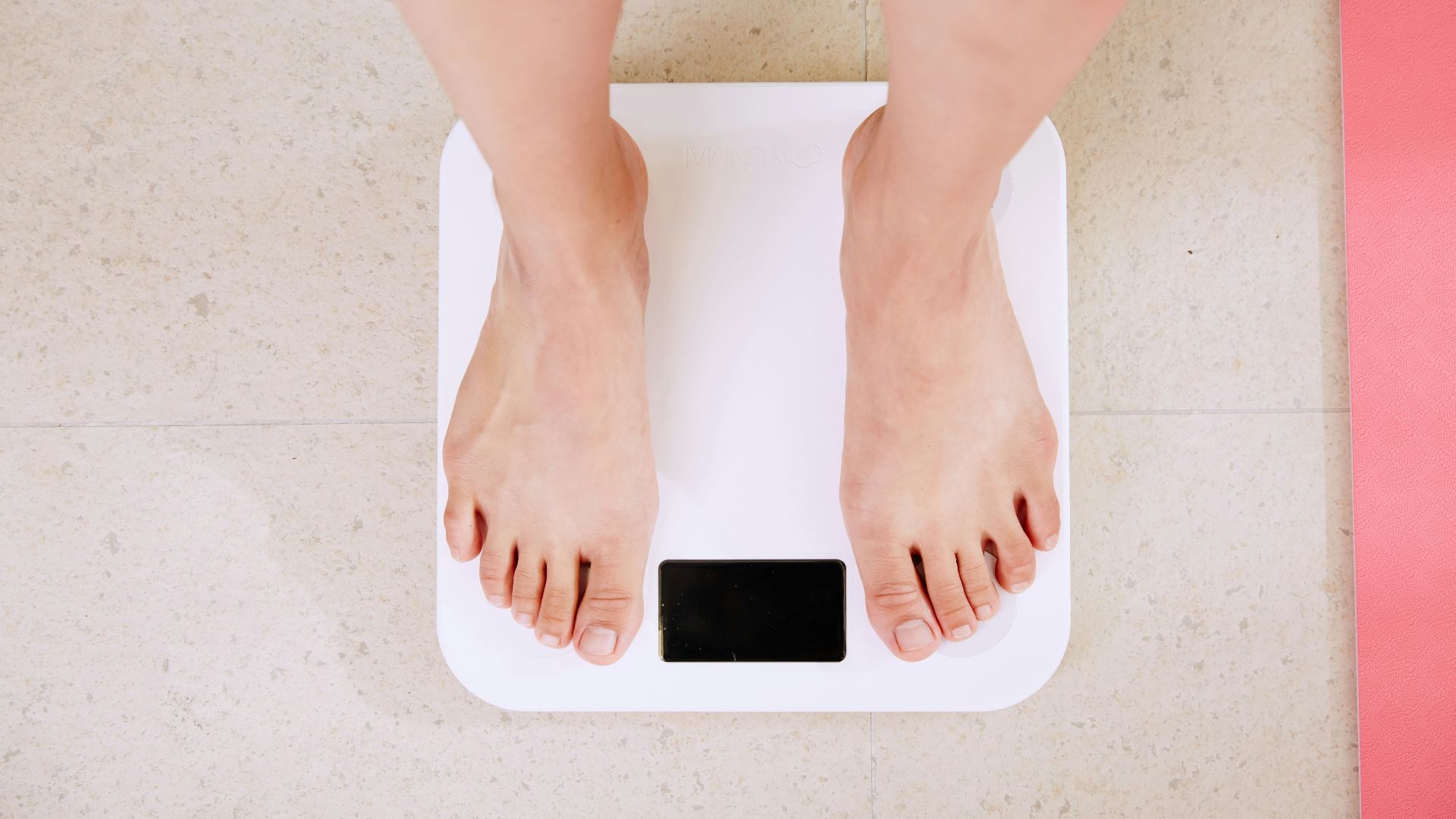 person standing on white digital bathroom scale