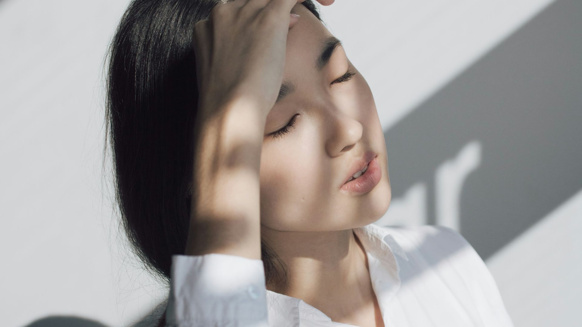 woman leaning on white table