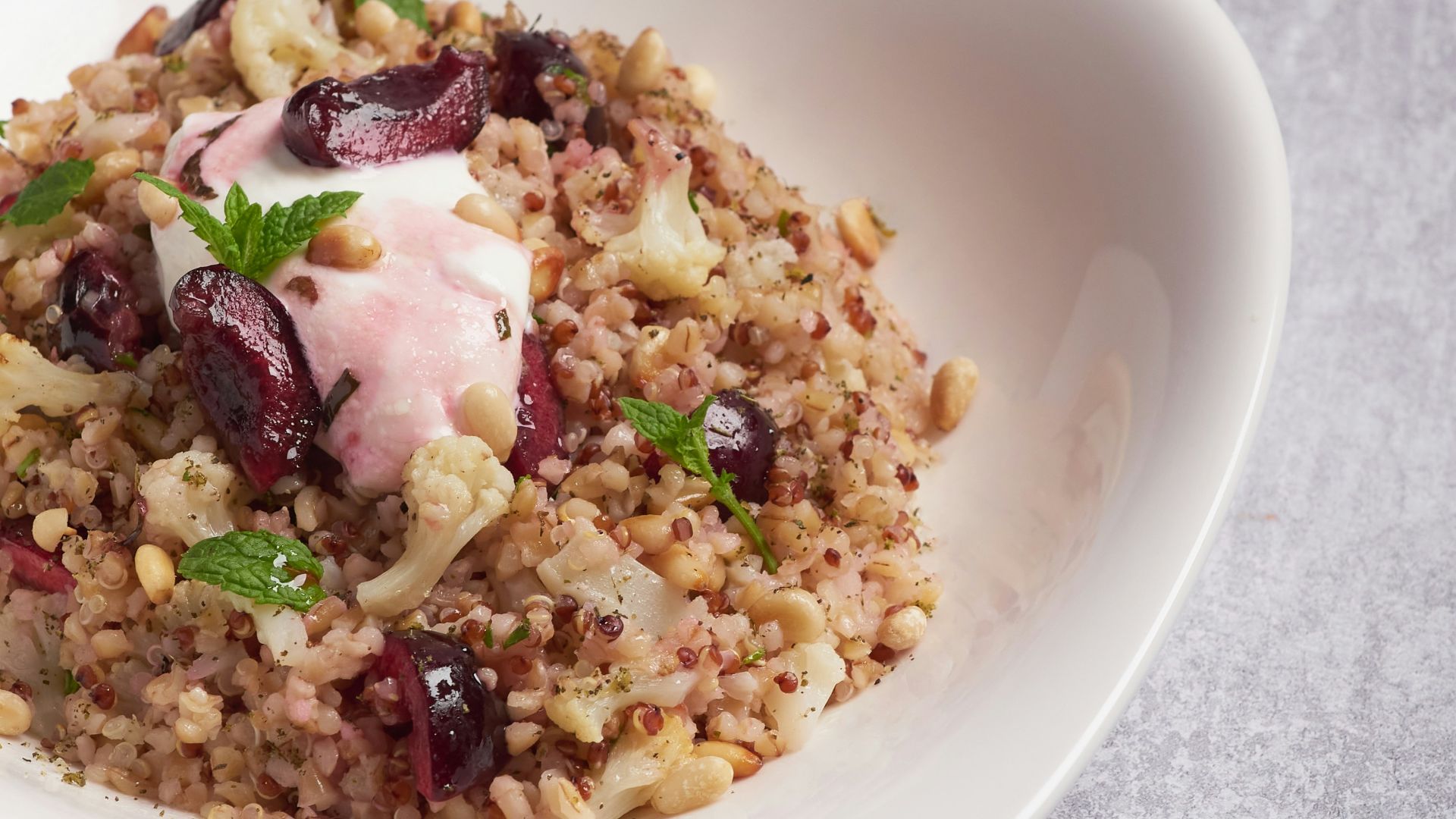 a white bowl filled with food on top of a table