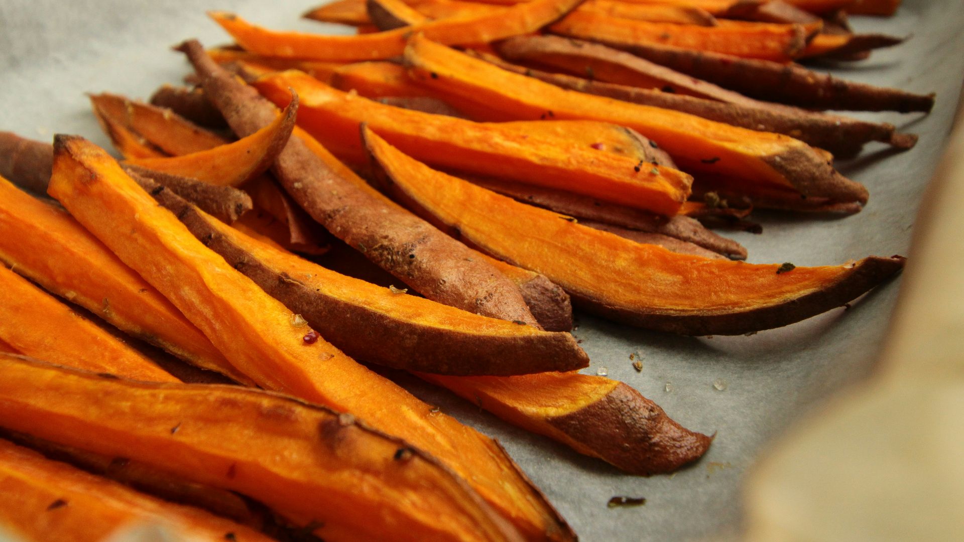 sliced orange fruit on white table