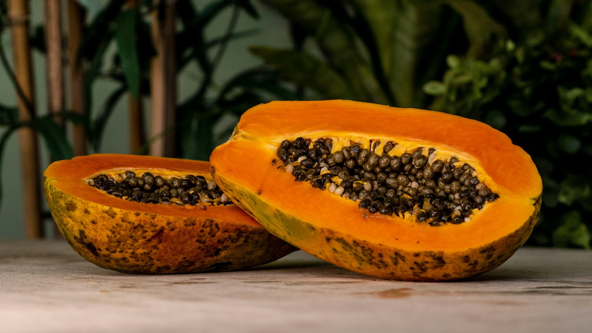 sliced papaya fruits on brown surface