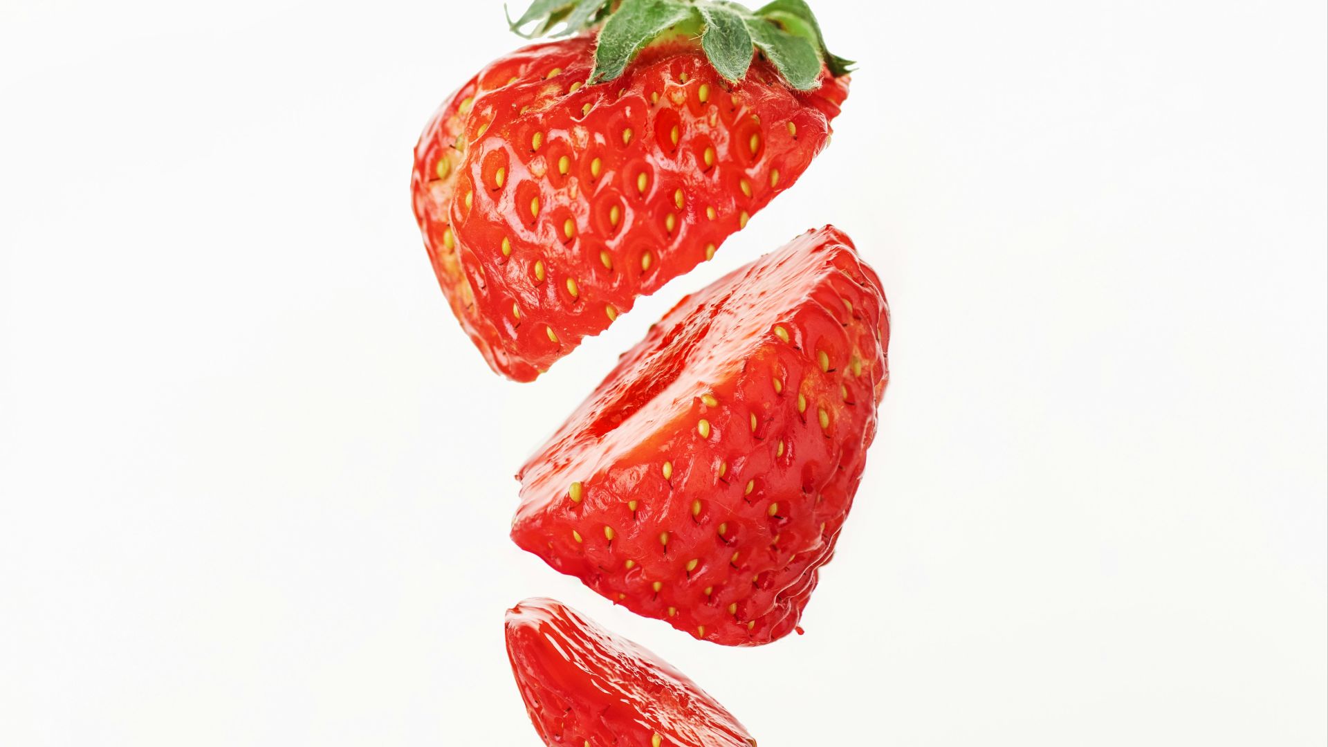 a group of strawberries flying through the air