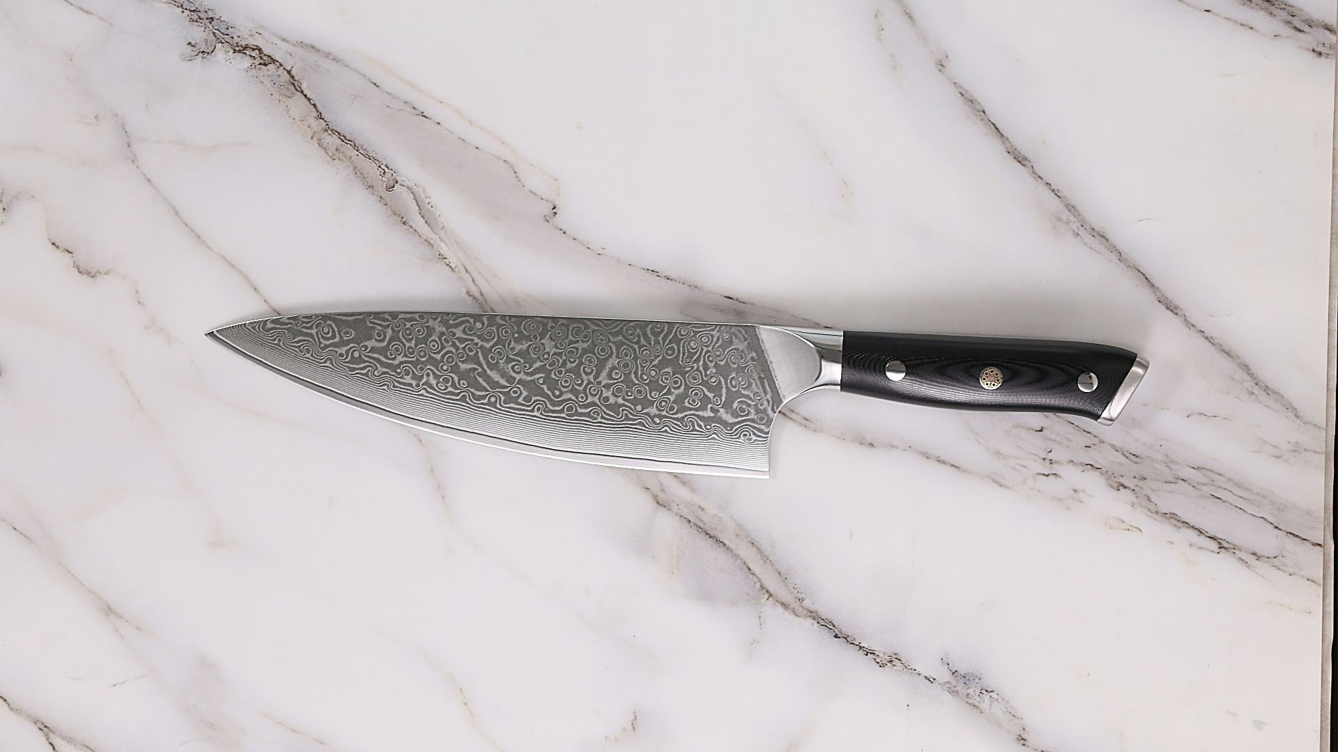 a large knife sitting on top of a marble counter