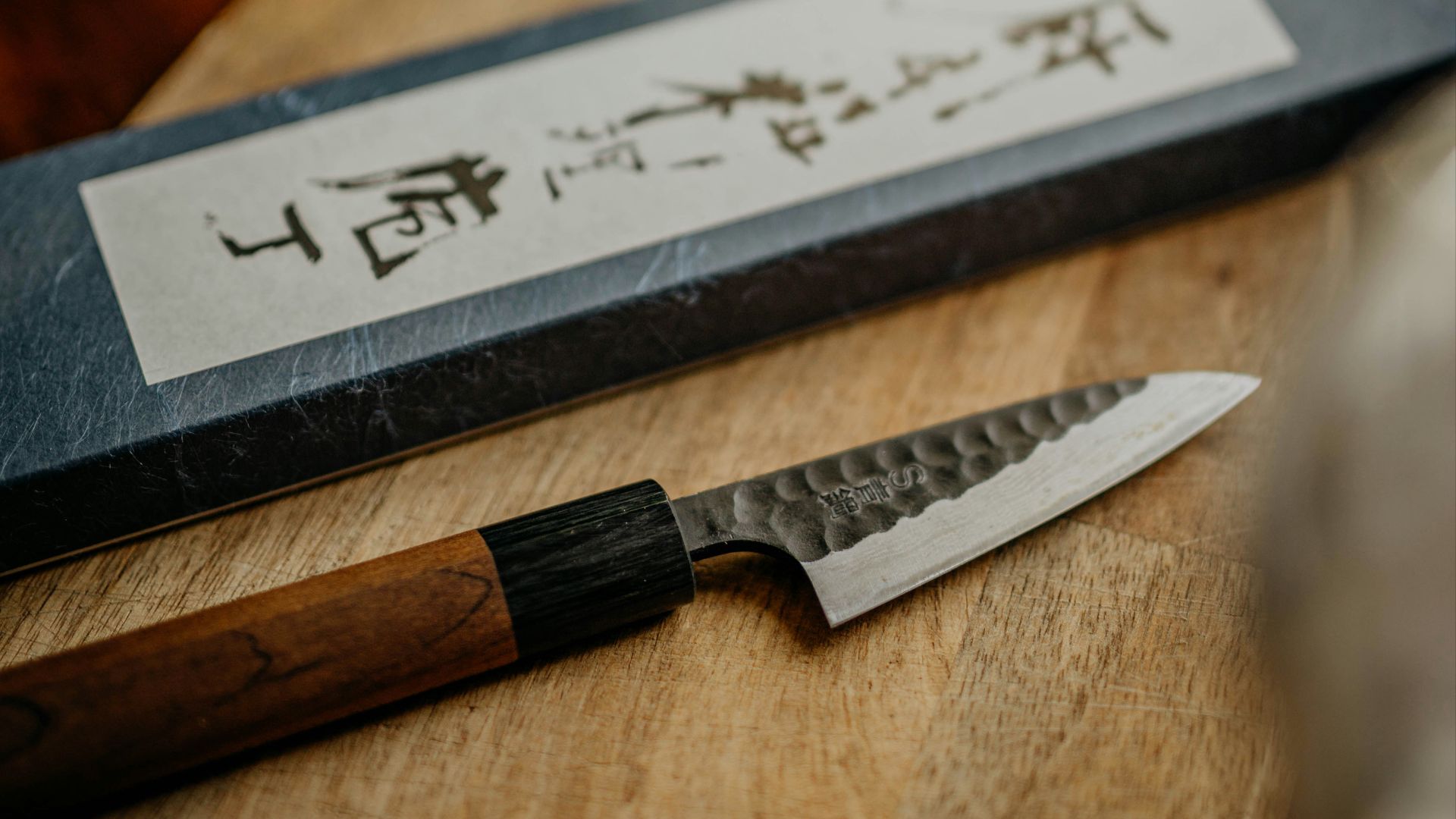 black and silver knife on brown wooden chopping board