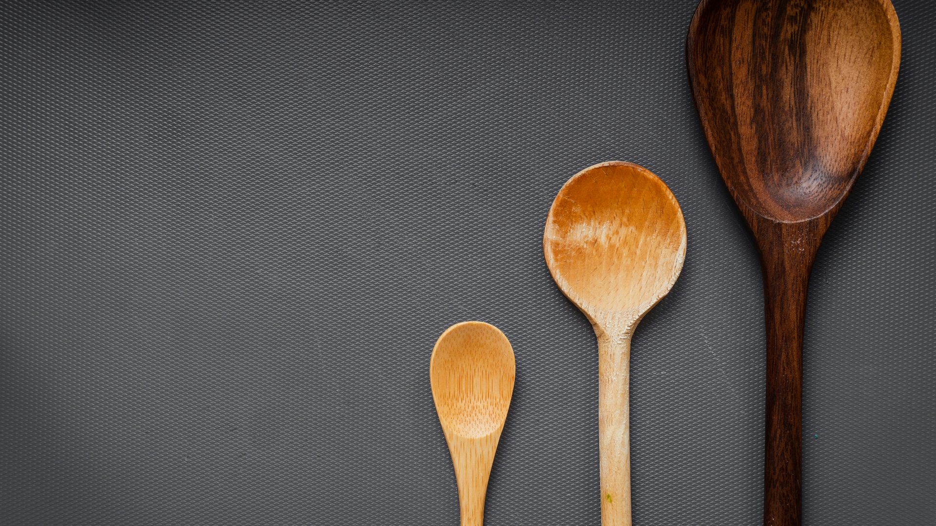 brown wooden spoon on gray textile
