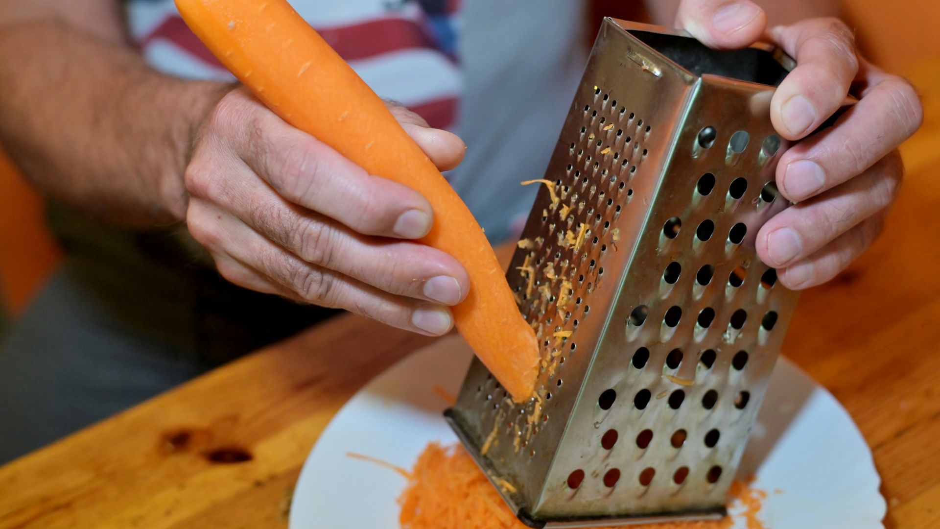 a person cutting a piece of bread
