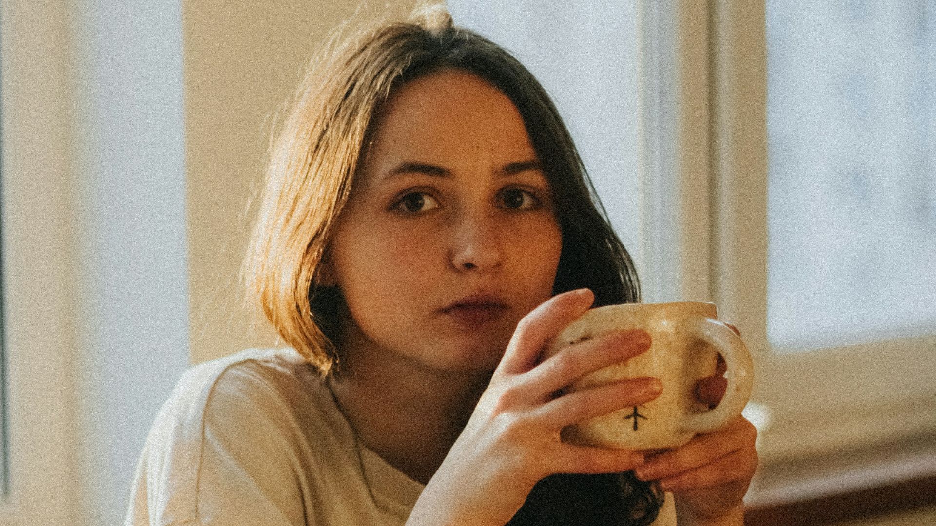 woman in white long sleeve shirt sitting on chair