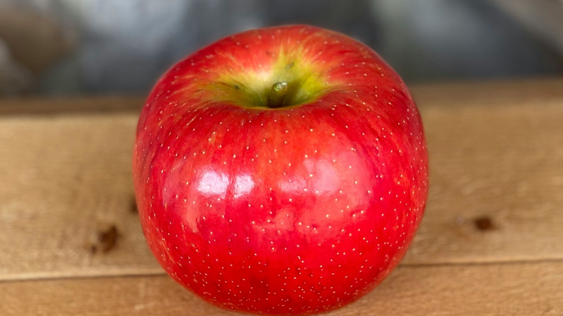 red apple fruit on brown wooden table