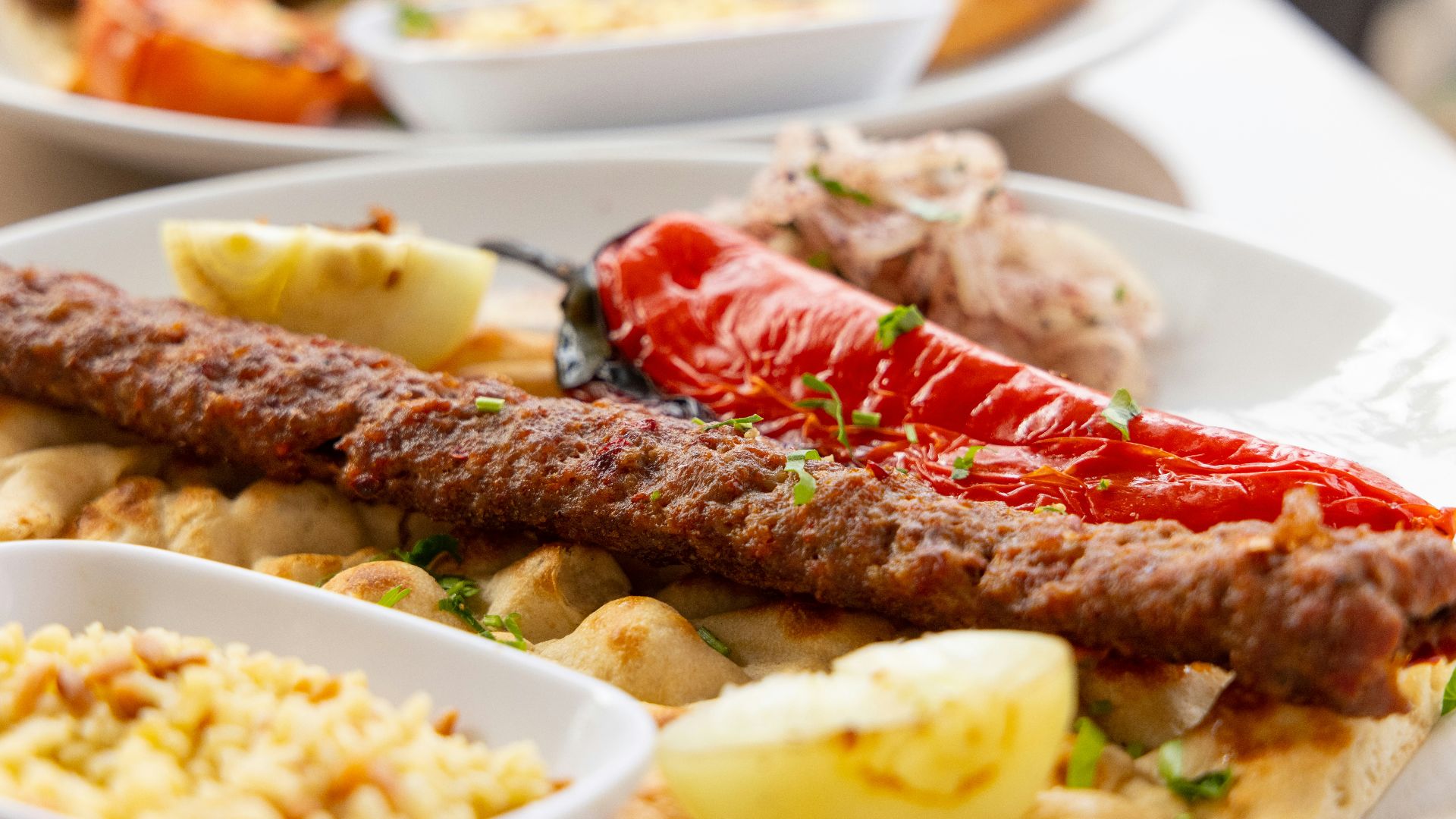 cooked meat with sliced lemon on white ceramic plate