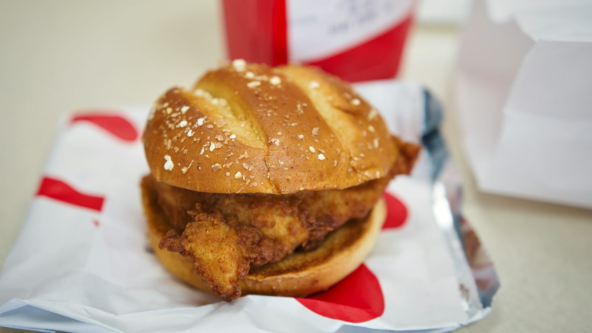 a chicken sandwich sitting on top of a piece of paper