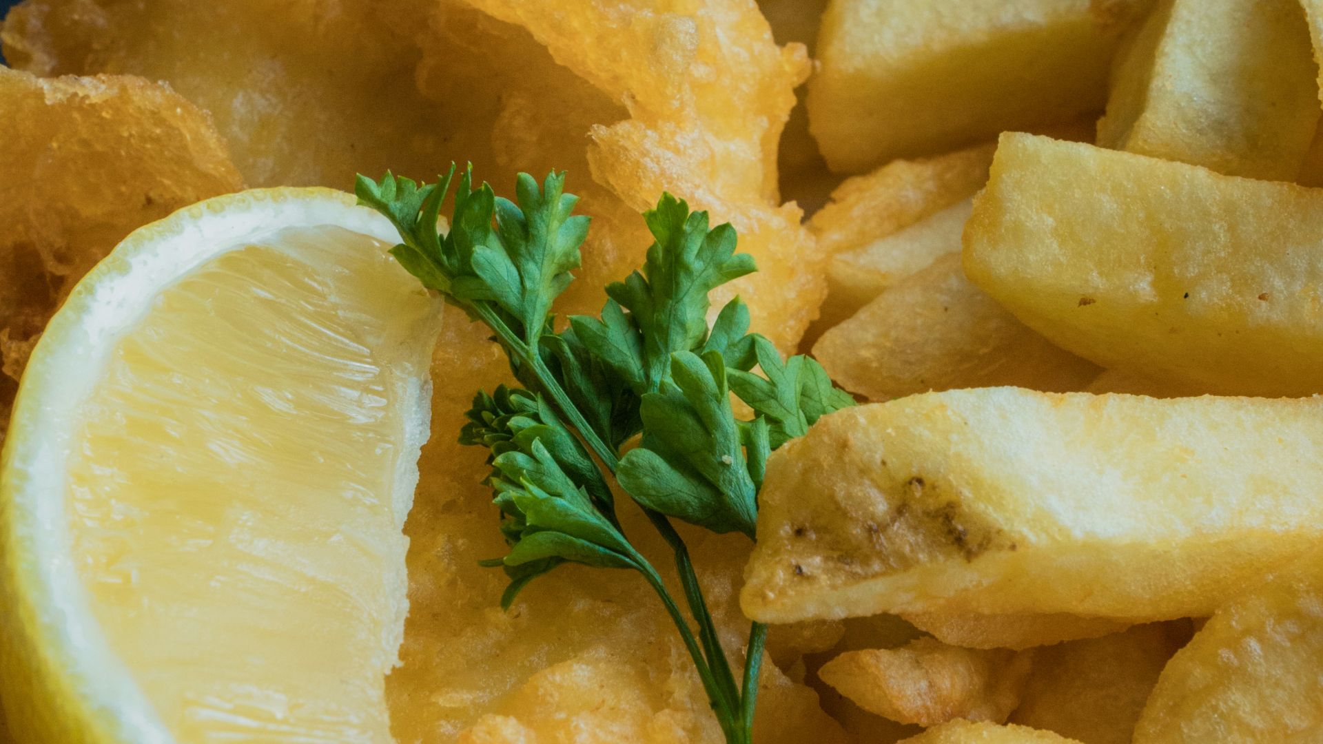 a white plate topped with fried fish and fries