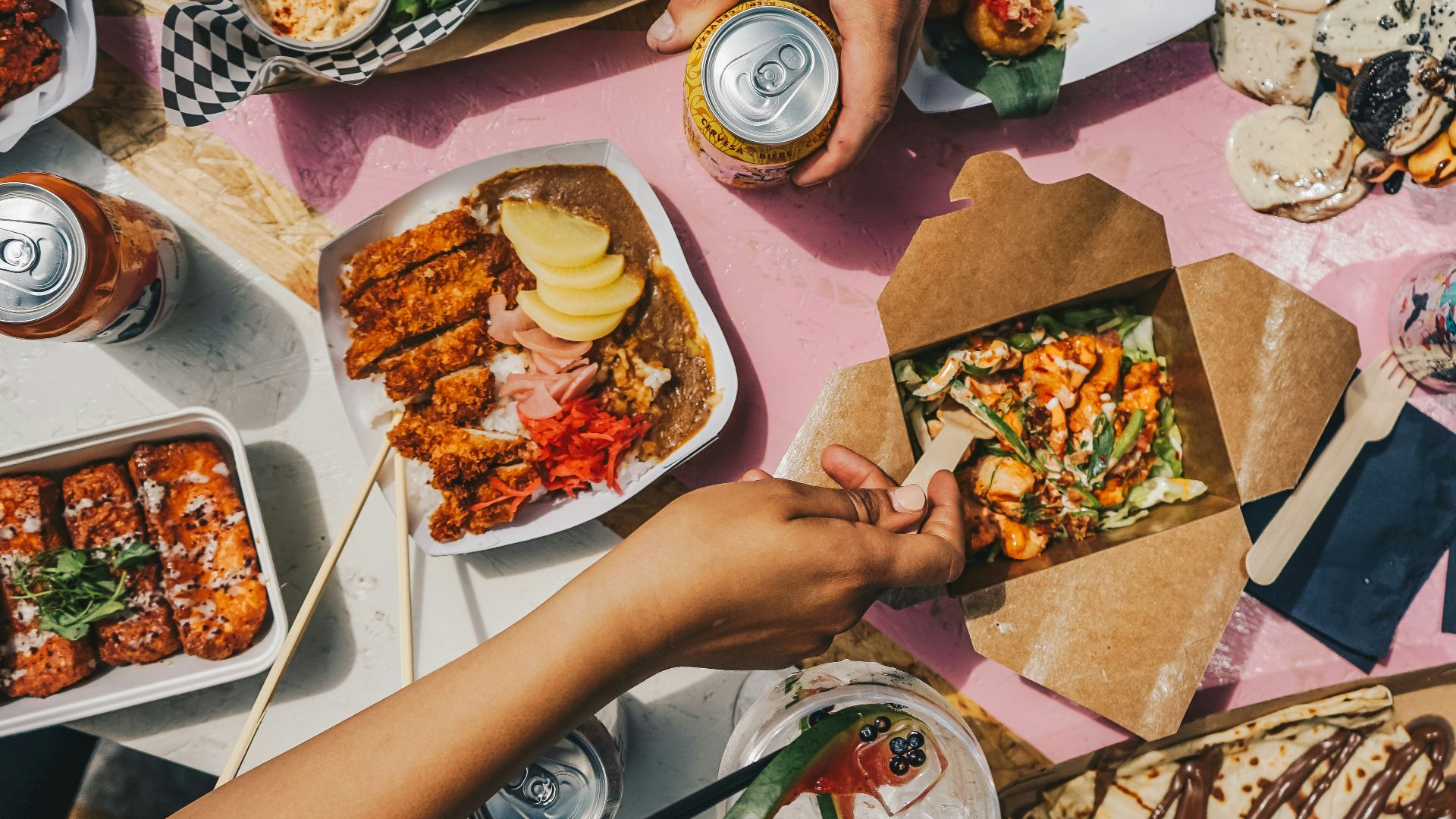 a group of people sitting around a table eating food