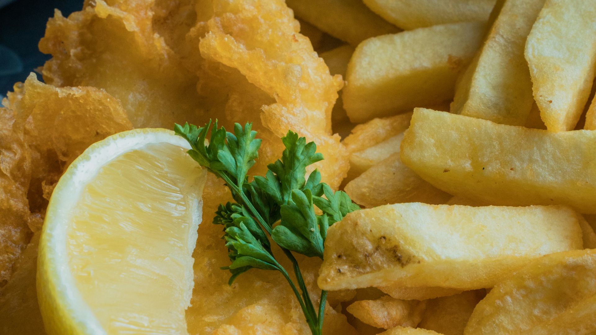 a white plate topped with fried fish and fries