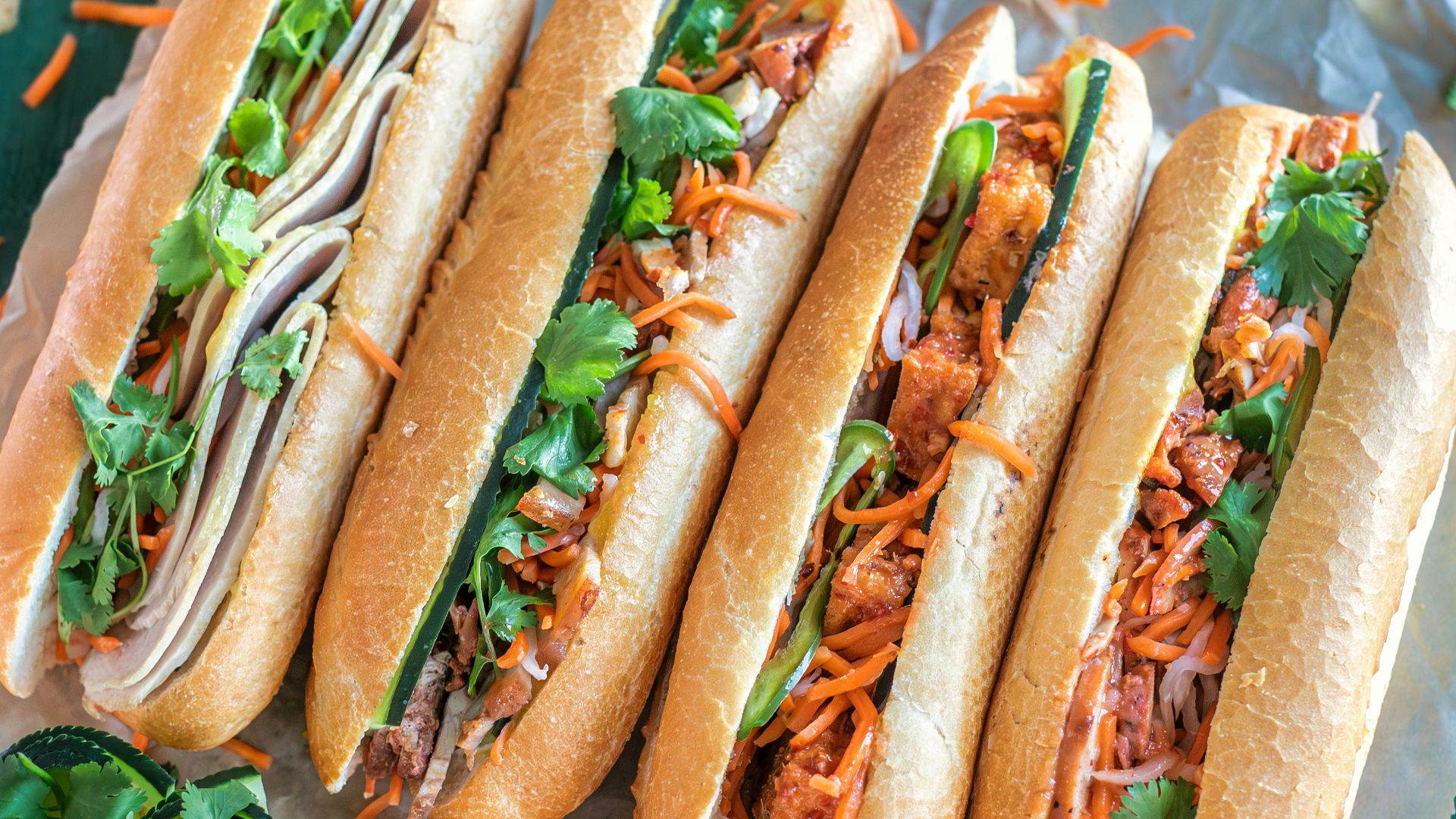 a bunch of hot dogs sitting on top of a table