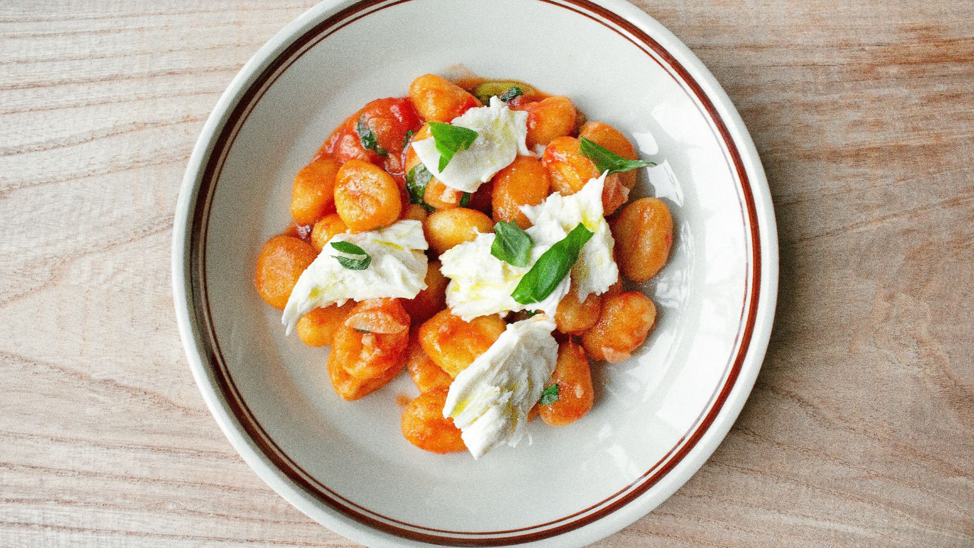 a white plate topped with food on top of a wooden table