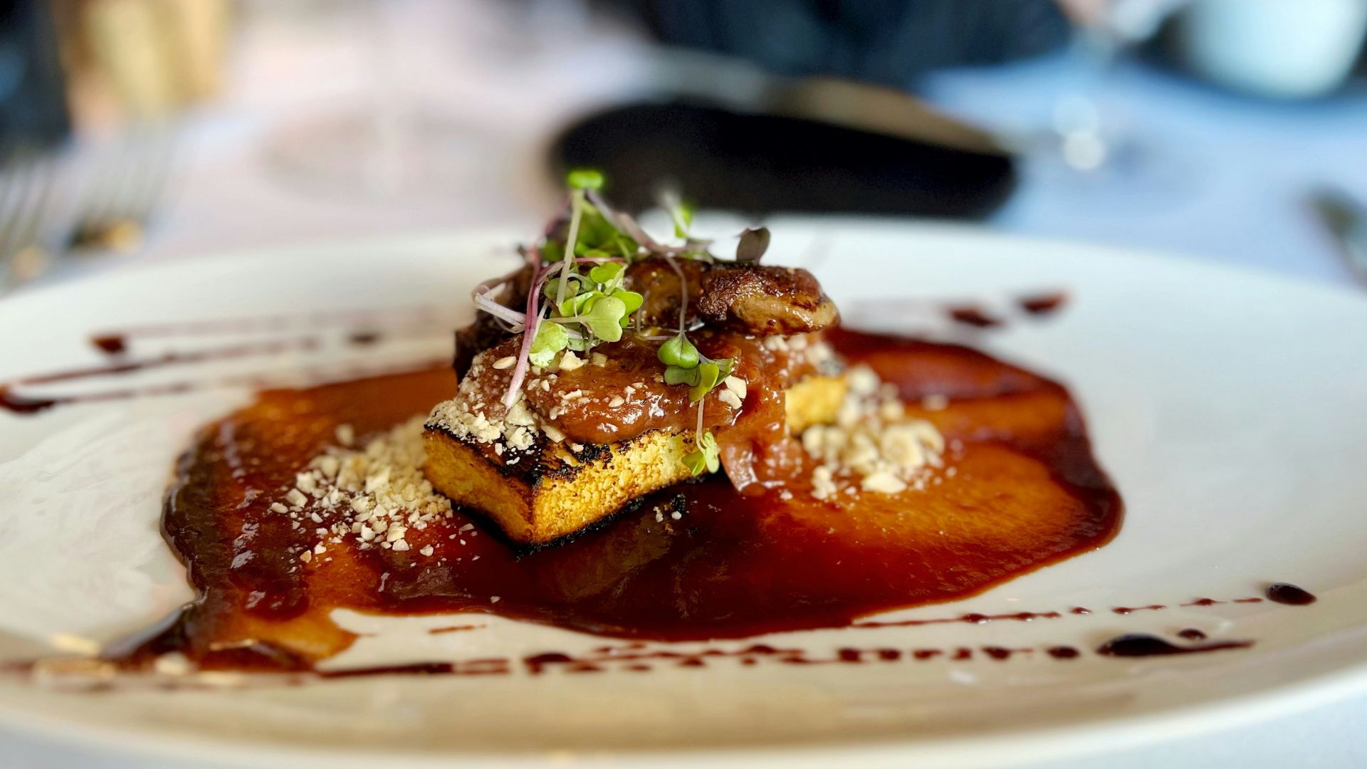 A white plate topped with food on top of a table