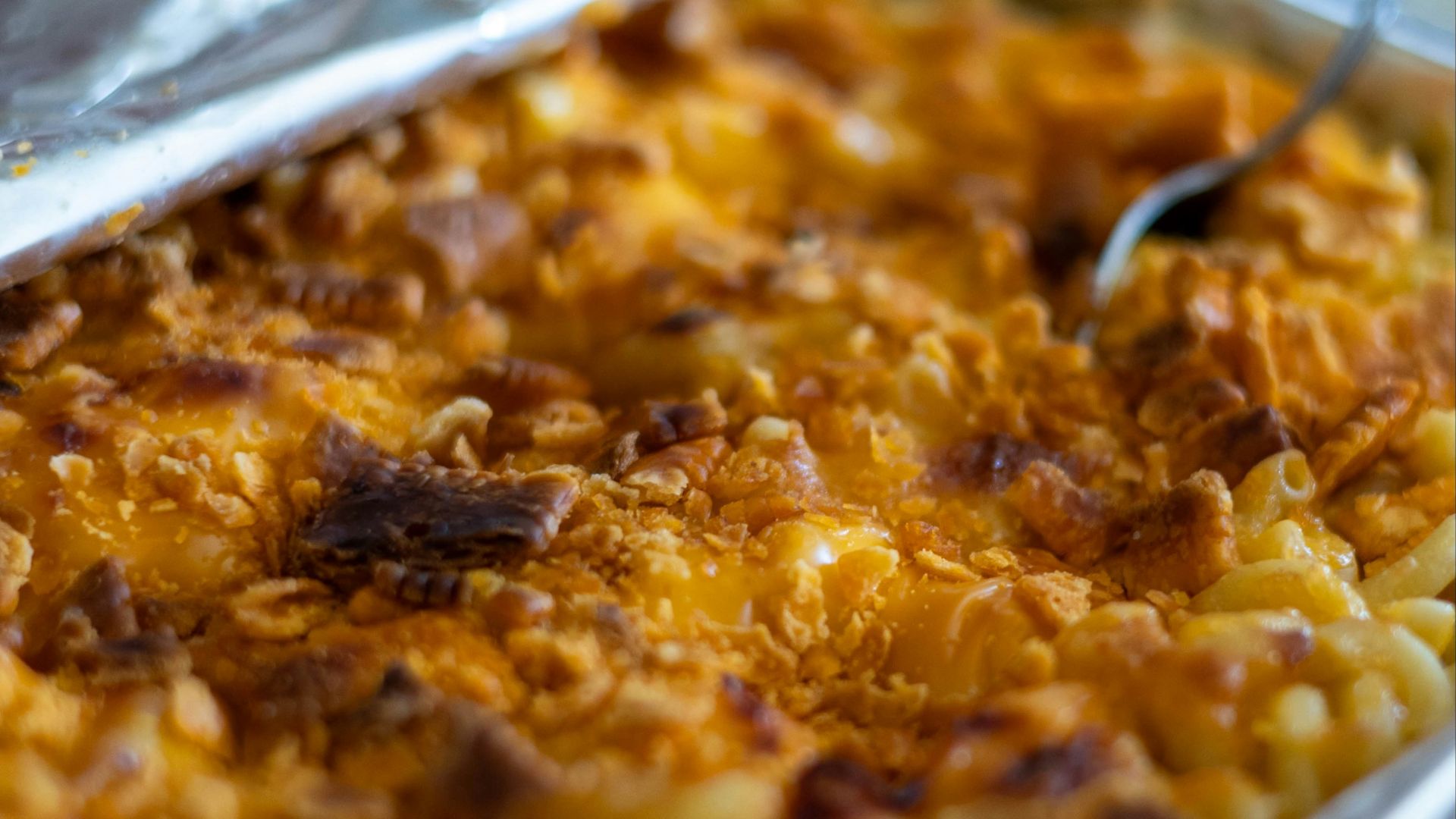 a dish of macaroni and cheese with a spoon in it