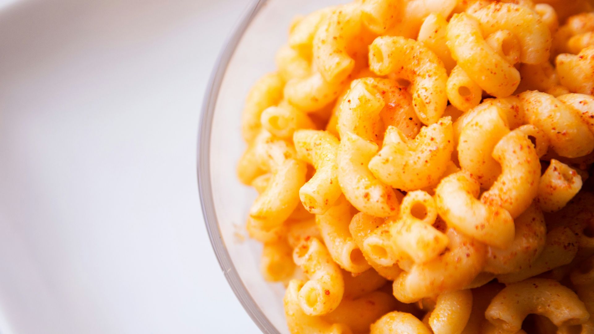 yellow pasta on clear glass bowl