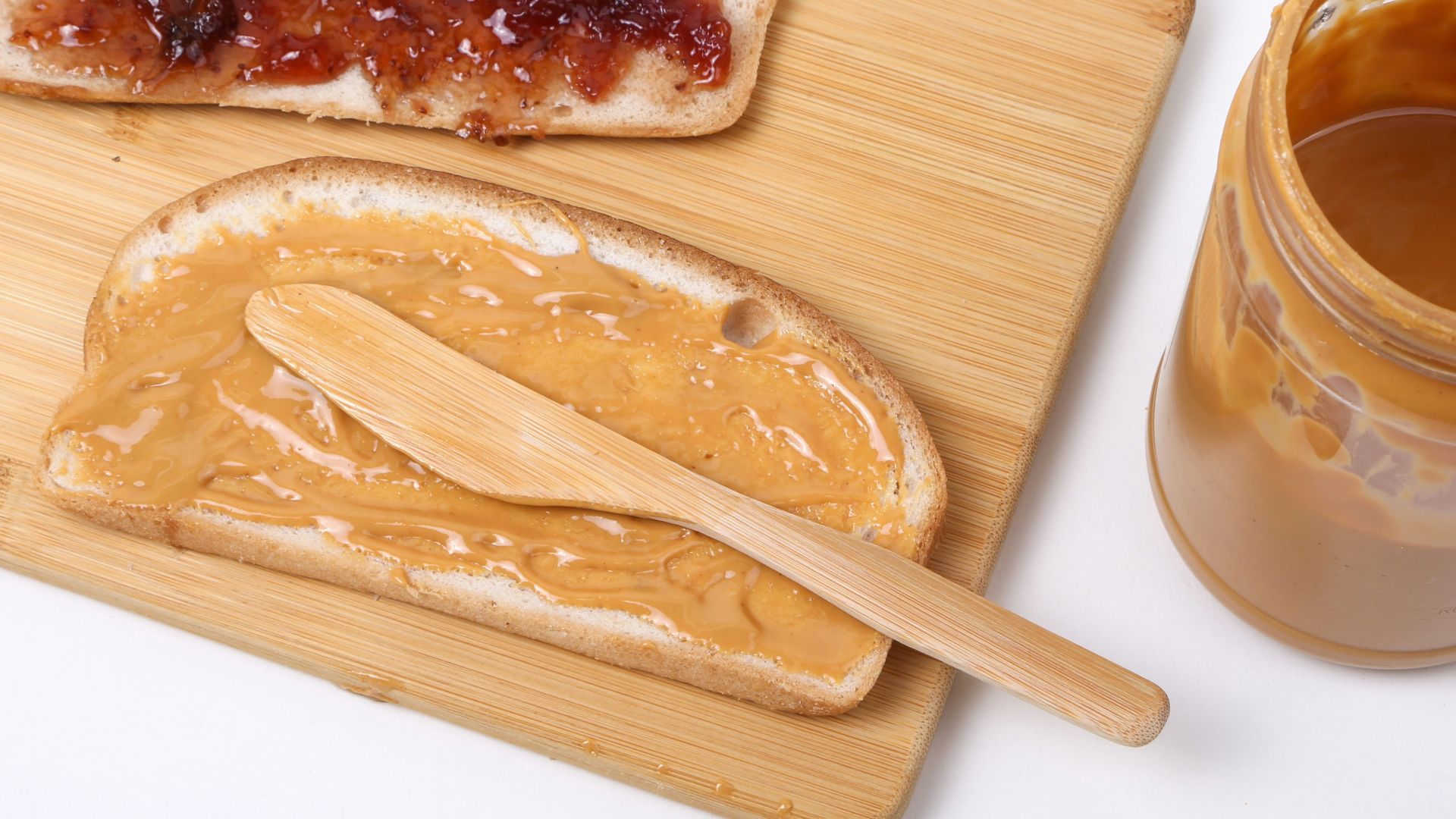 a wooden spoon next to a bowl of food