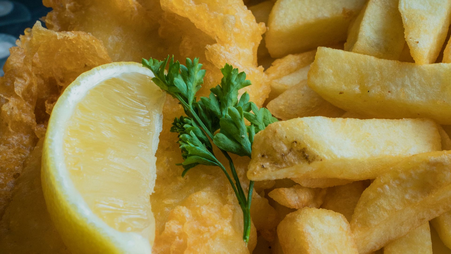 a white plate topped with fried fish and fries