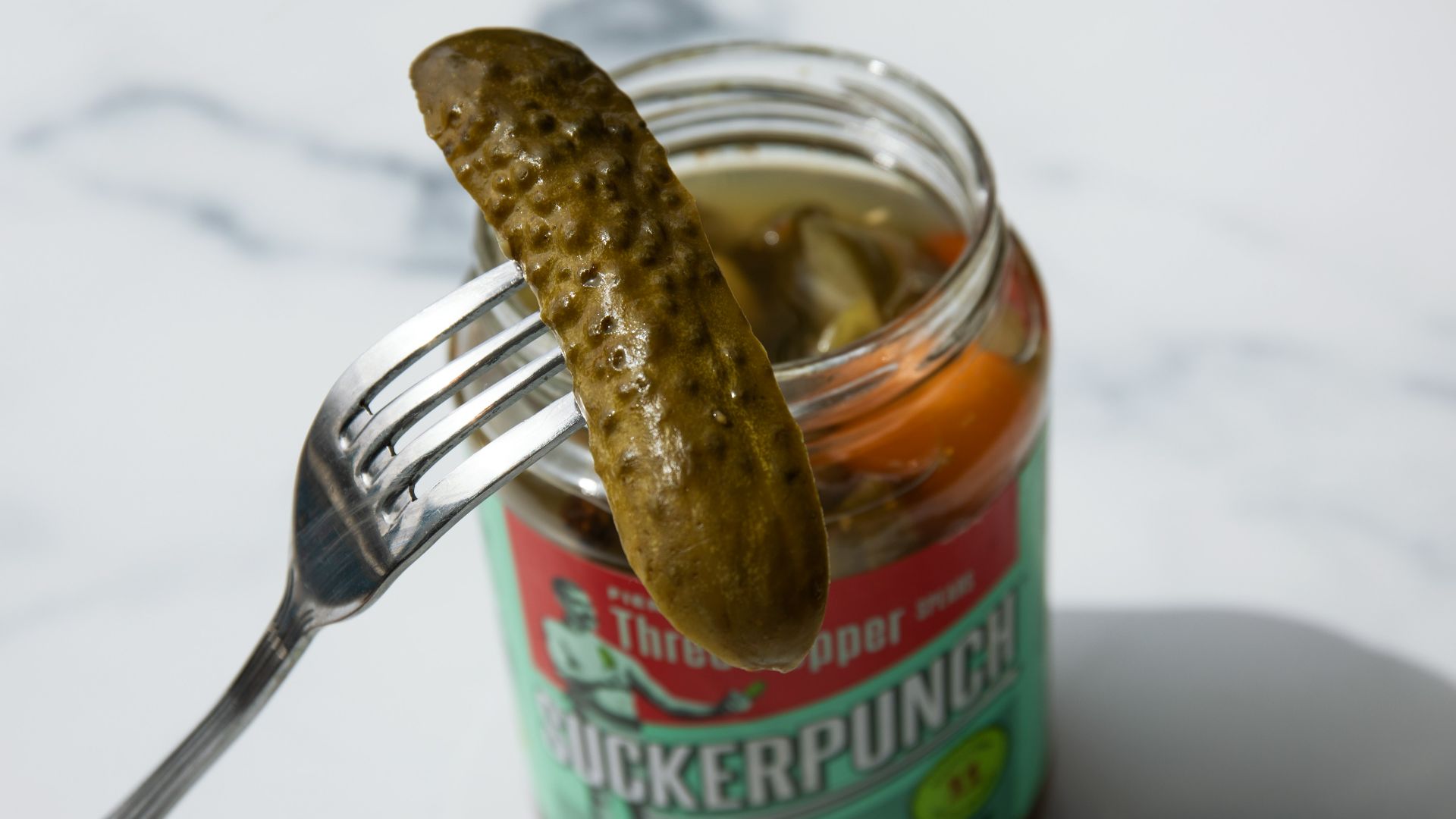 stainless steel fork on green labeled can