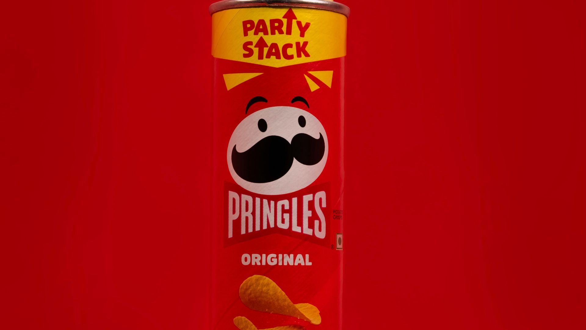 a can of pringles on a red background