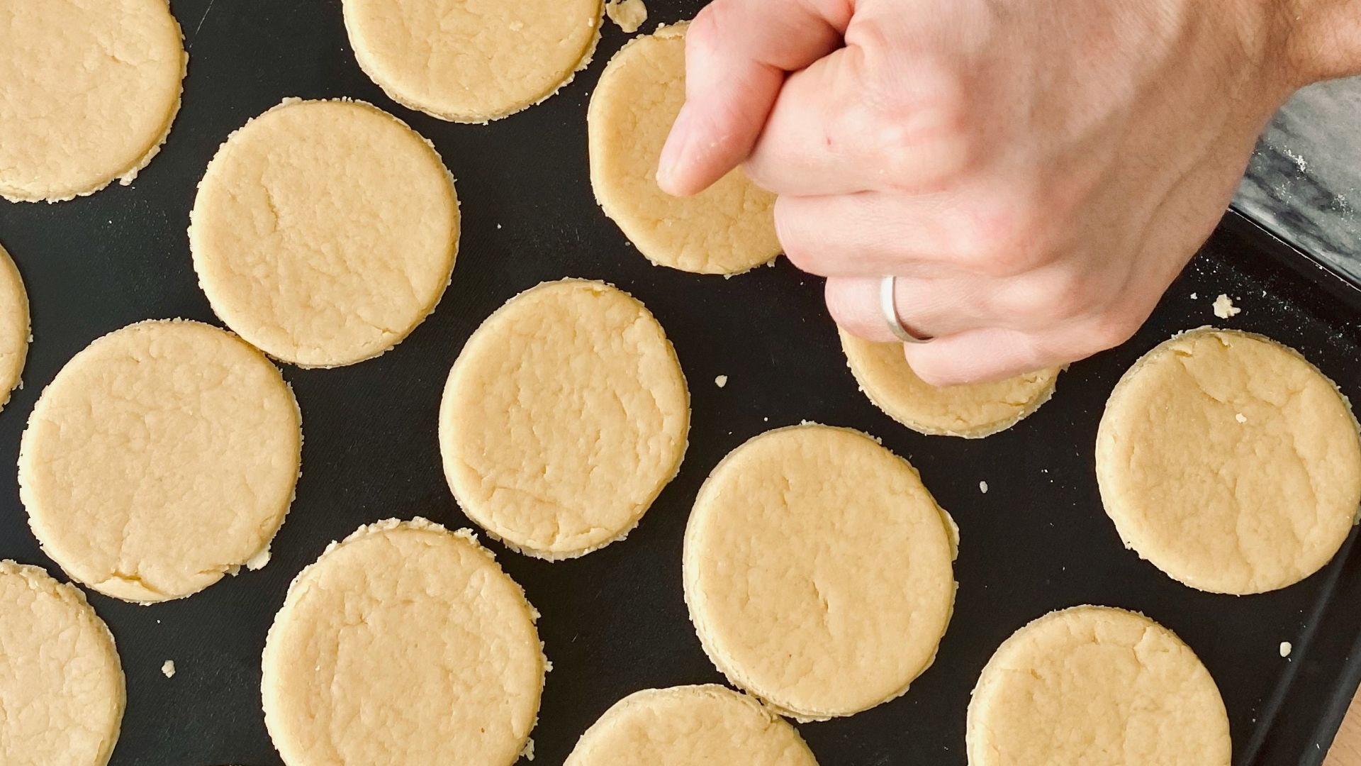 person holding brown wooden rolling pin