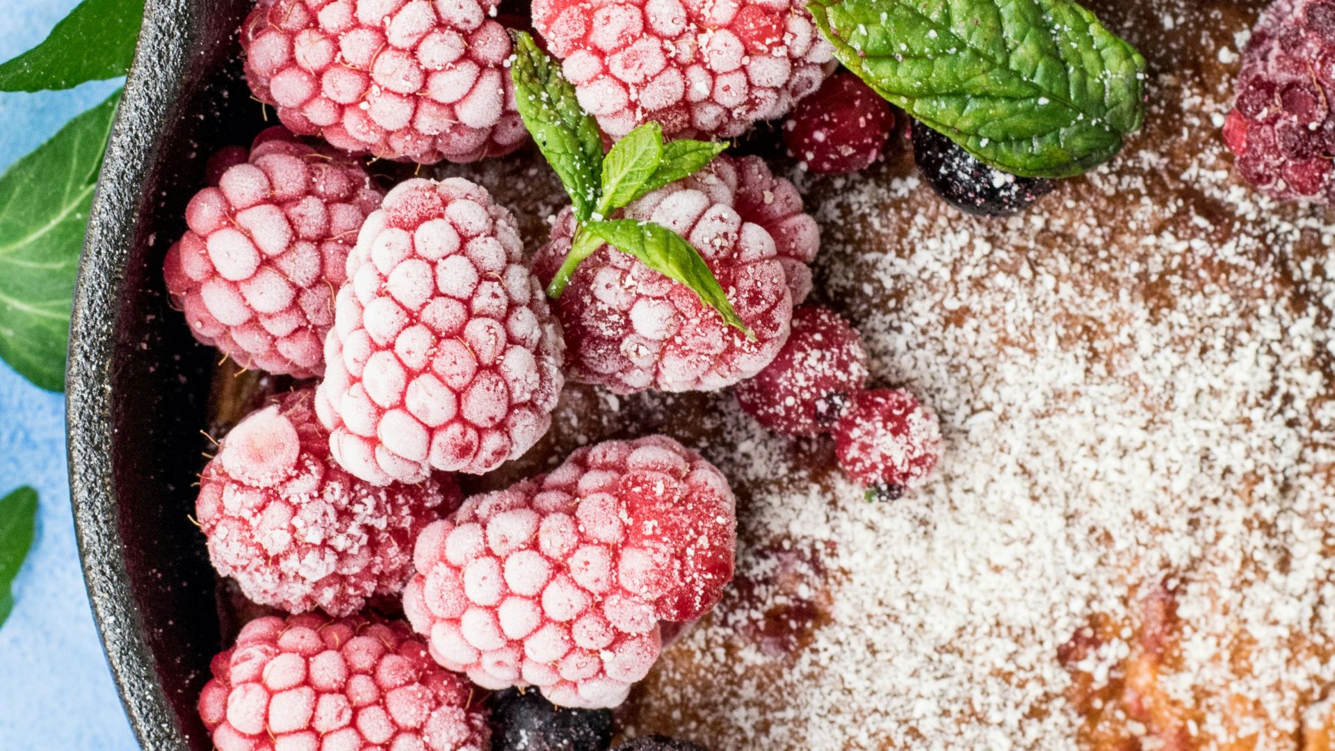 raspberries on black bowl