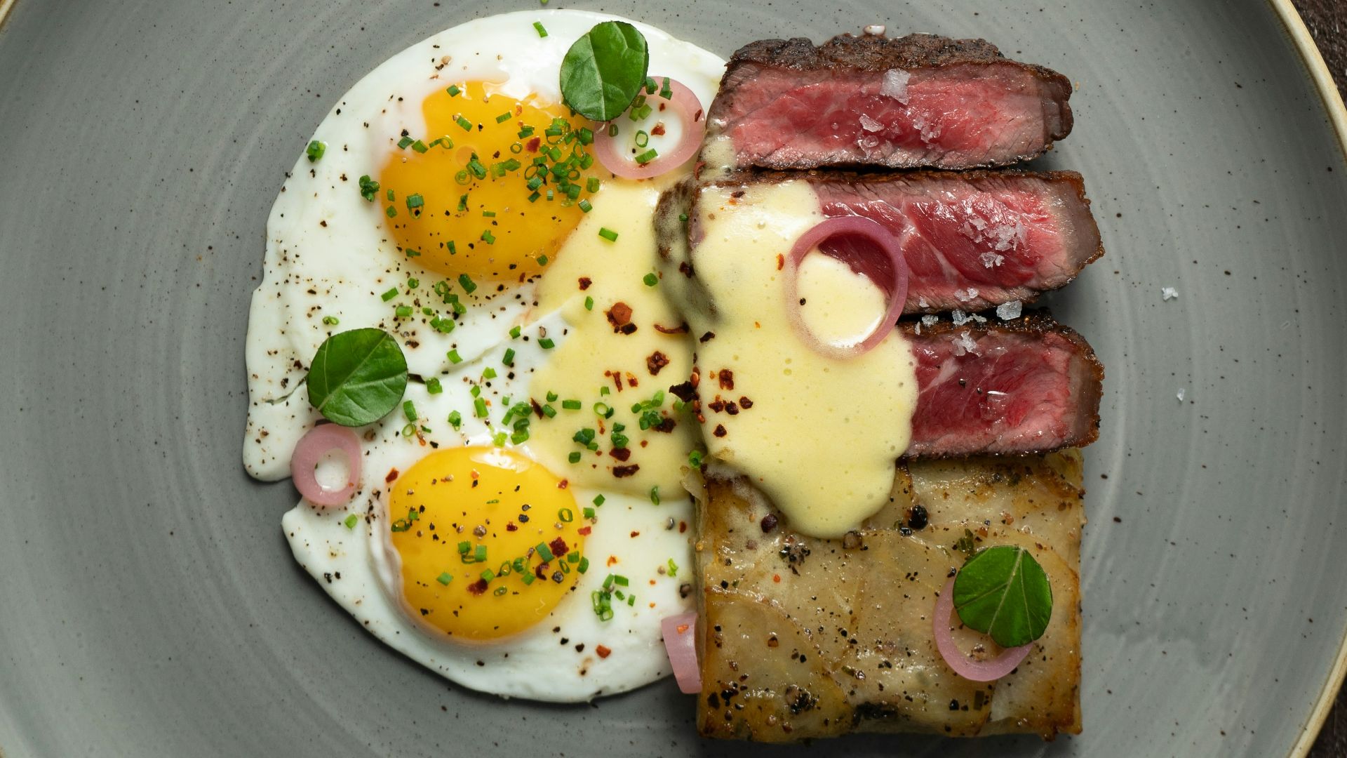 a plate of food with eggs and meat on it