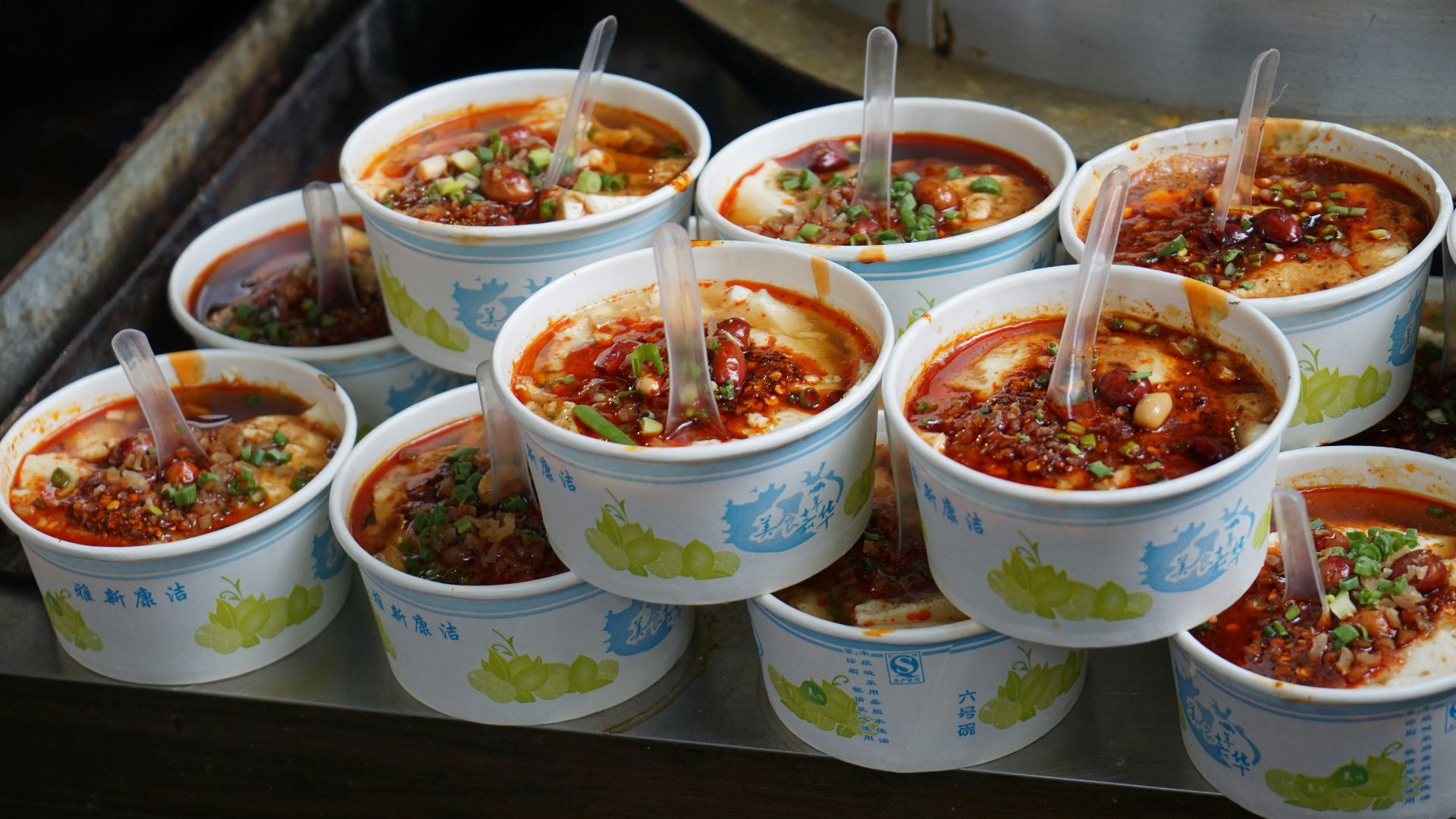 A bunch of bowls of food sitting on a table