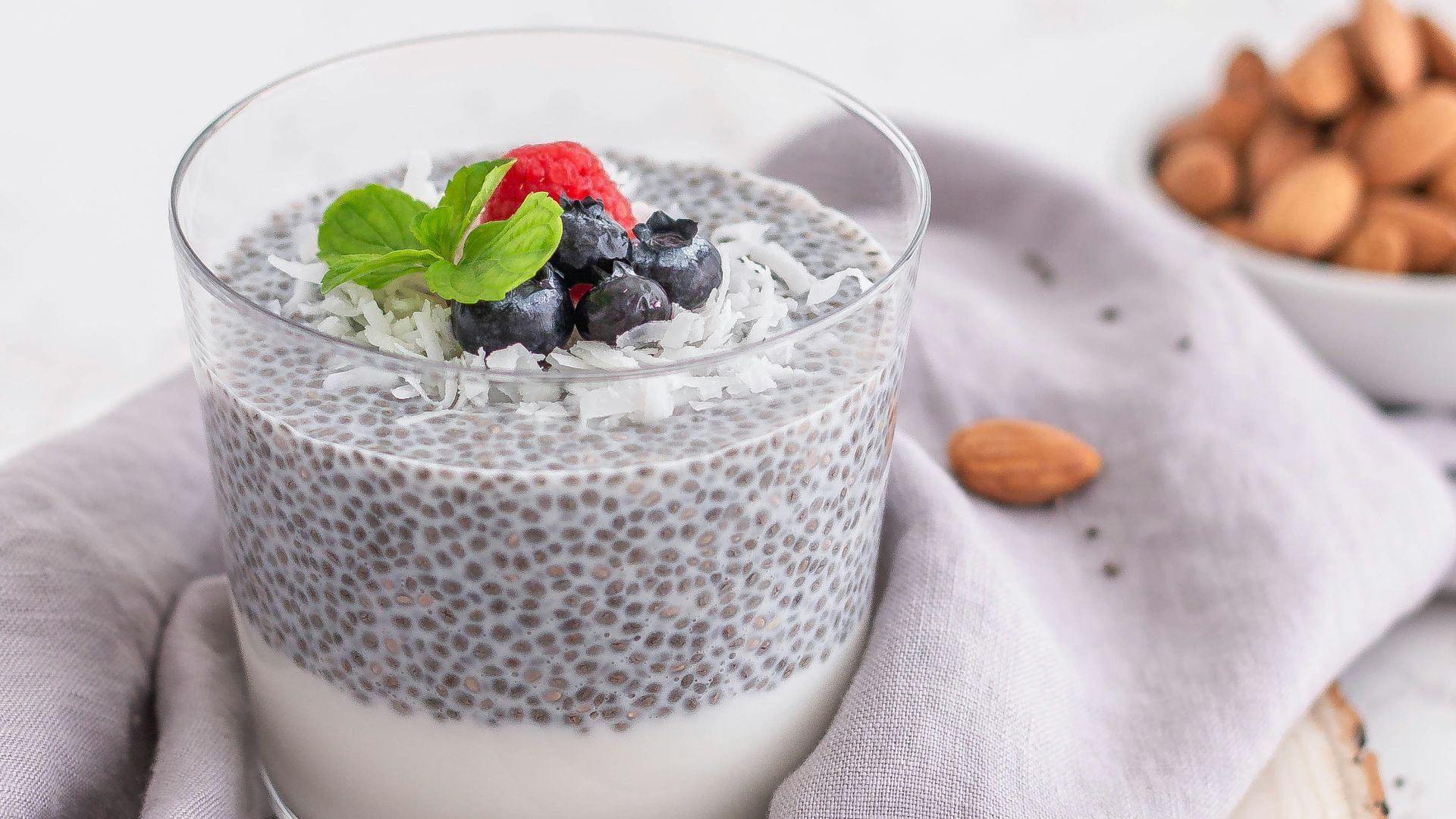 a glass of milk with berries and a spoon