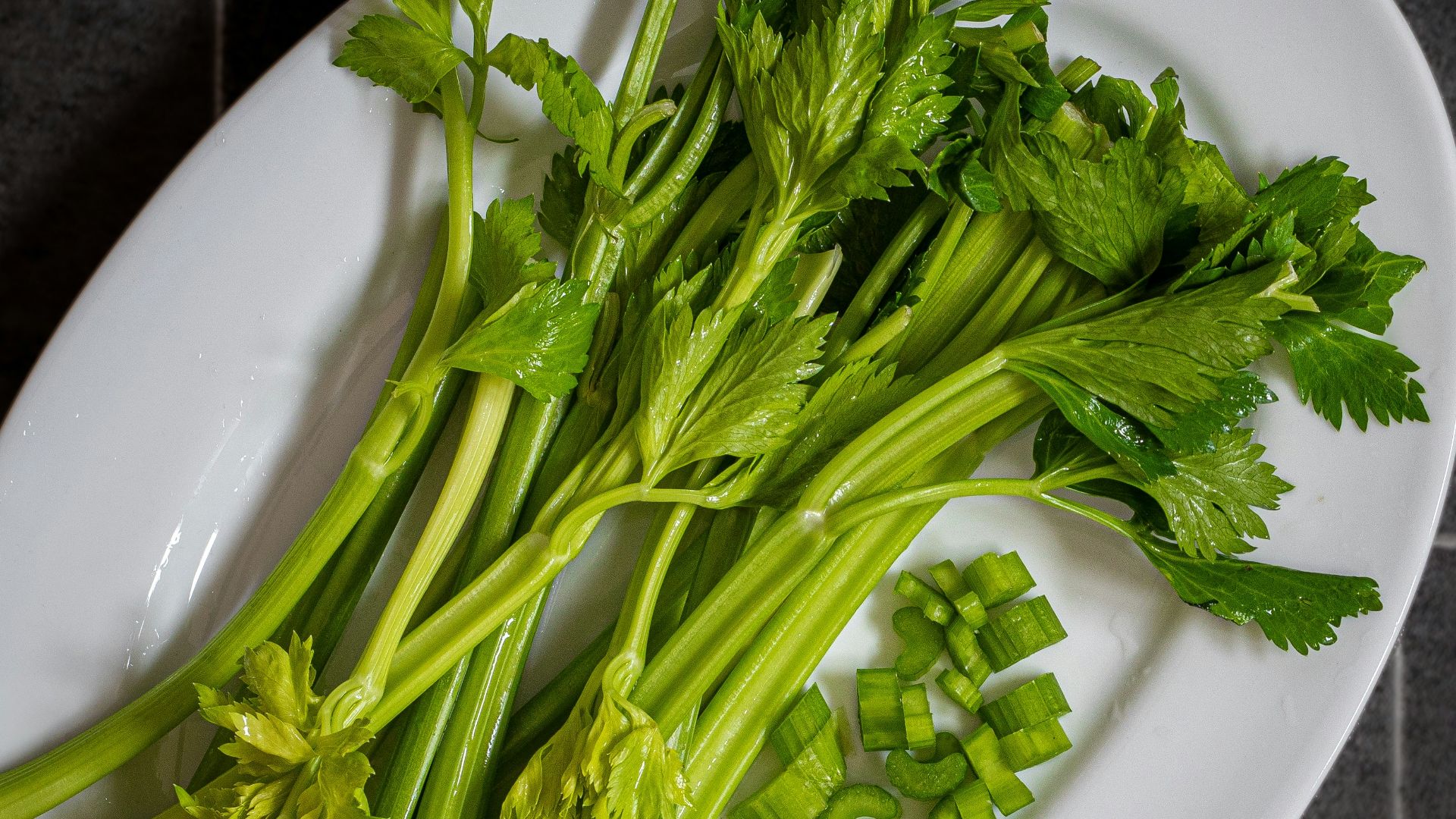 a white plate topped with green leafy vegetables