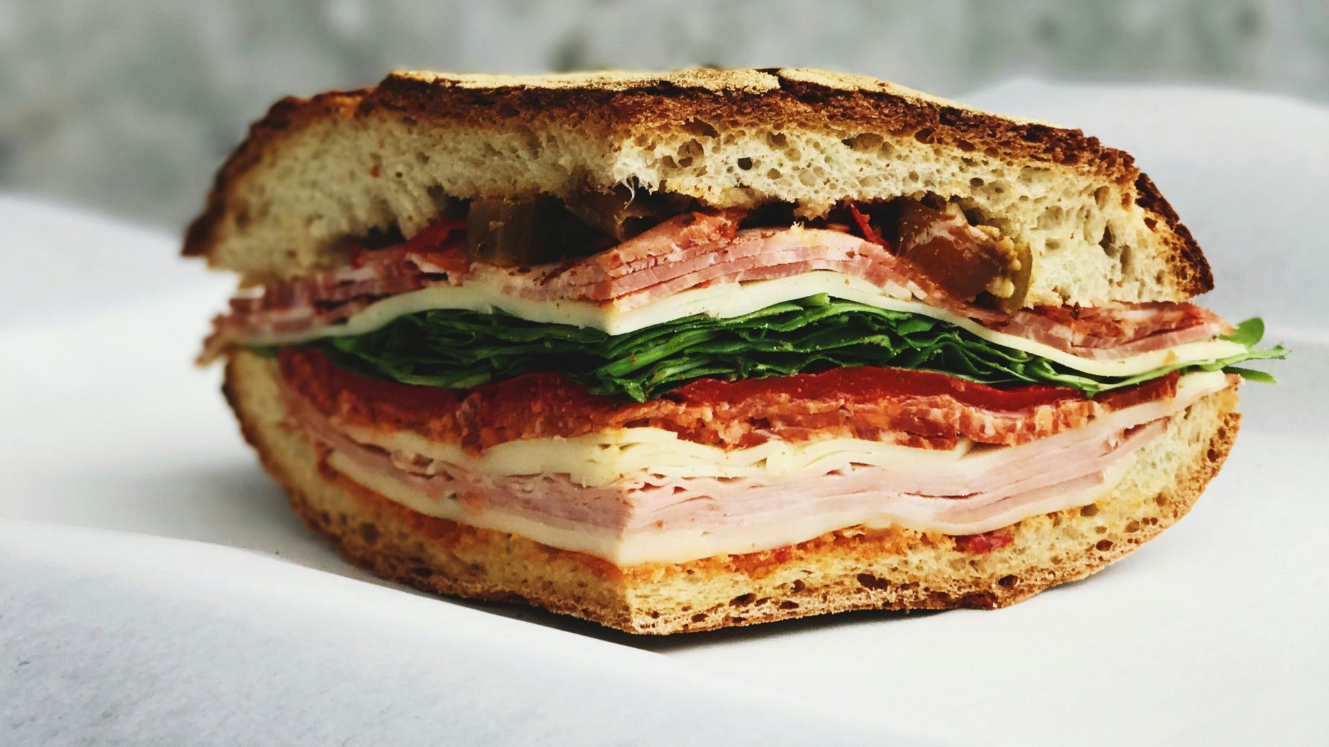 ham sandwich on white surface