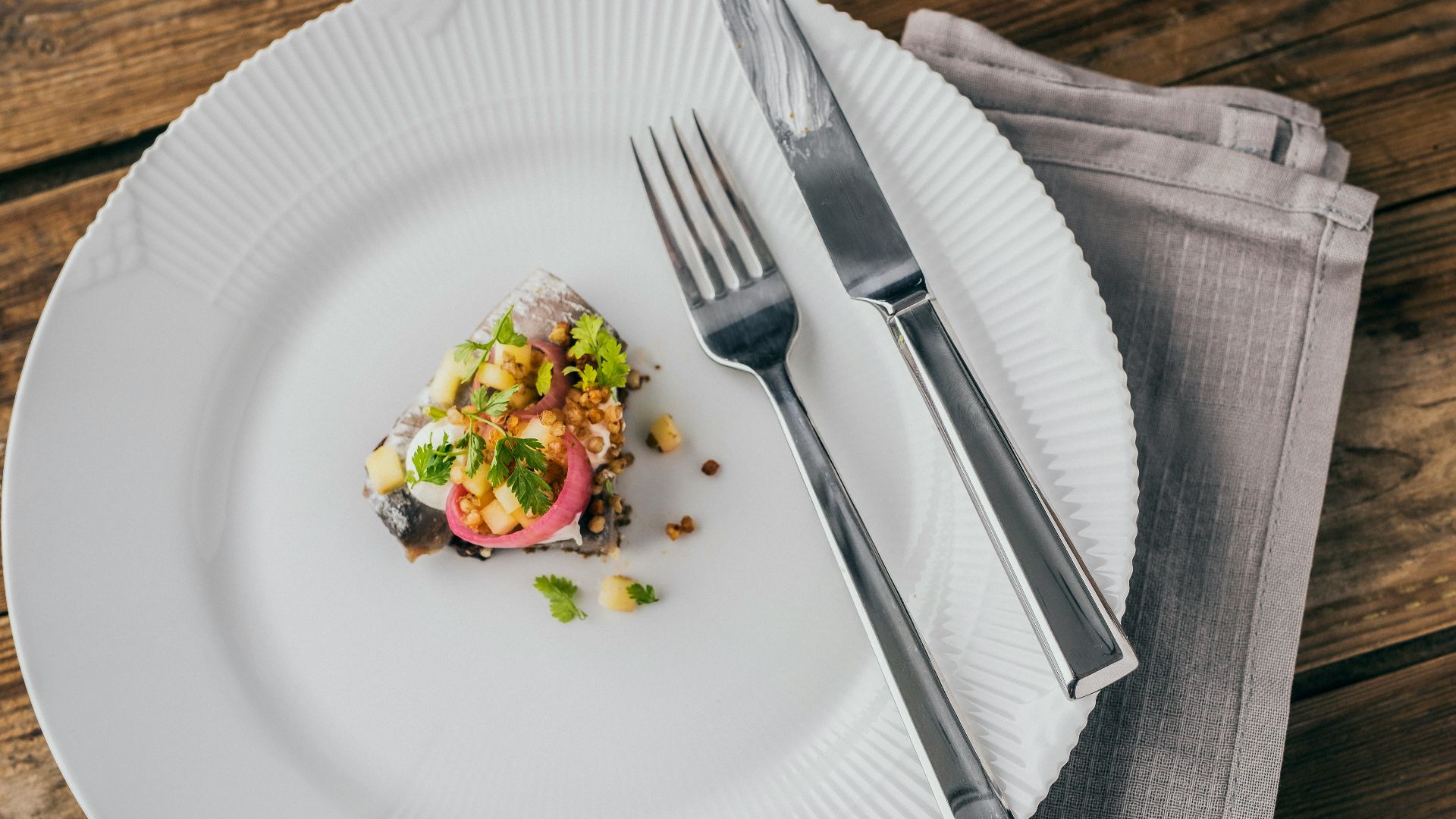 a white plate topped with food next to a fork