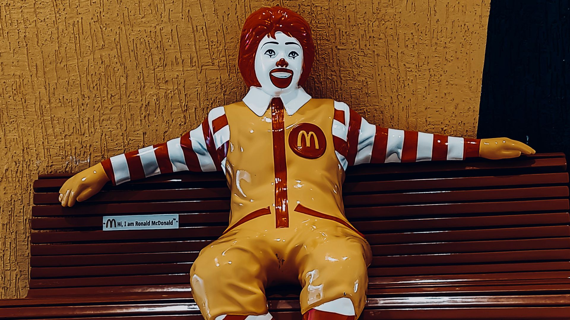 a clown sitting on a bench
