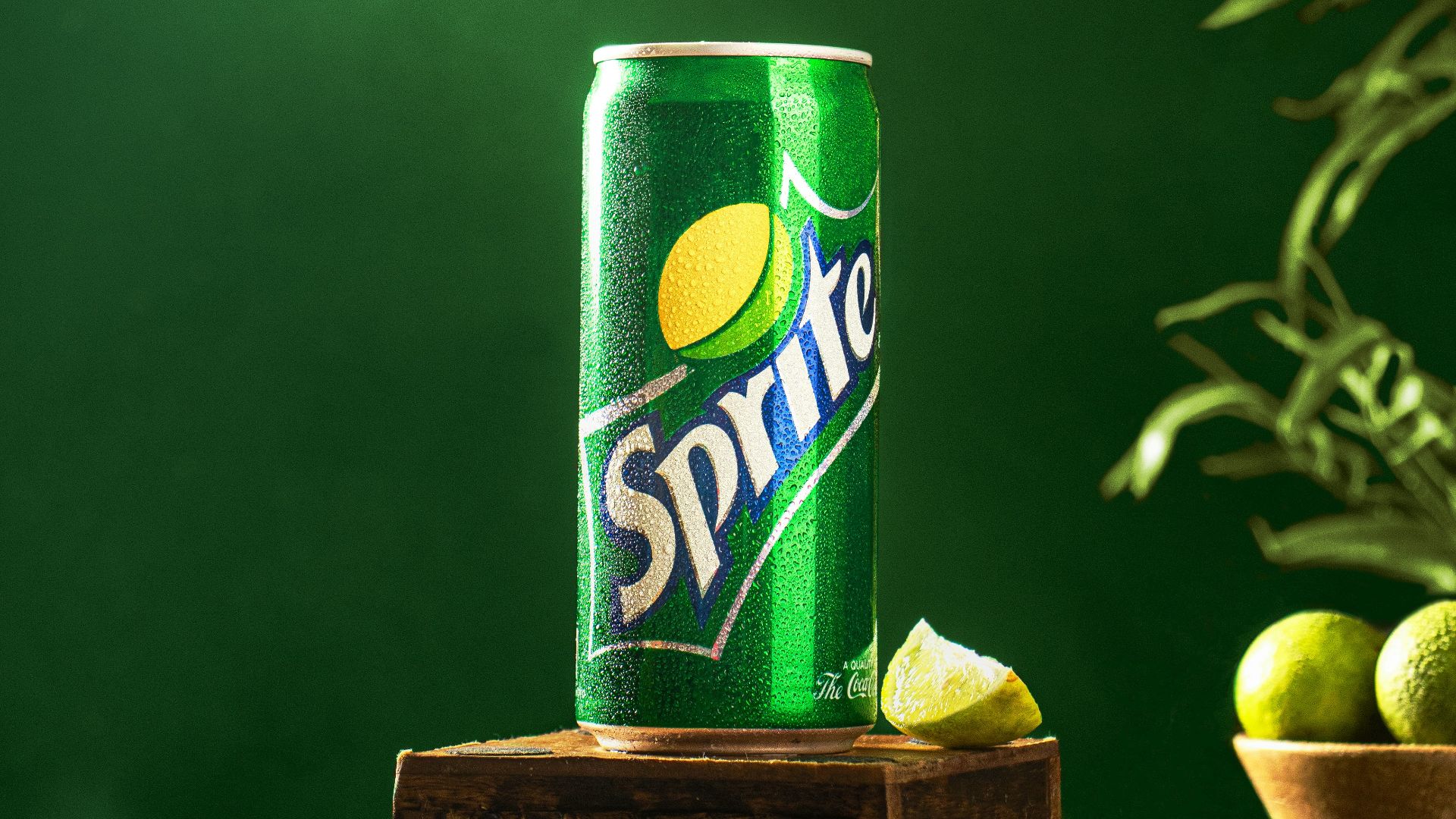 a can of sprite on a wooden stand with limes