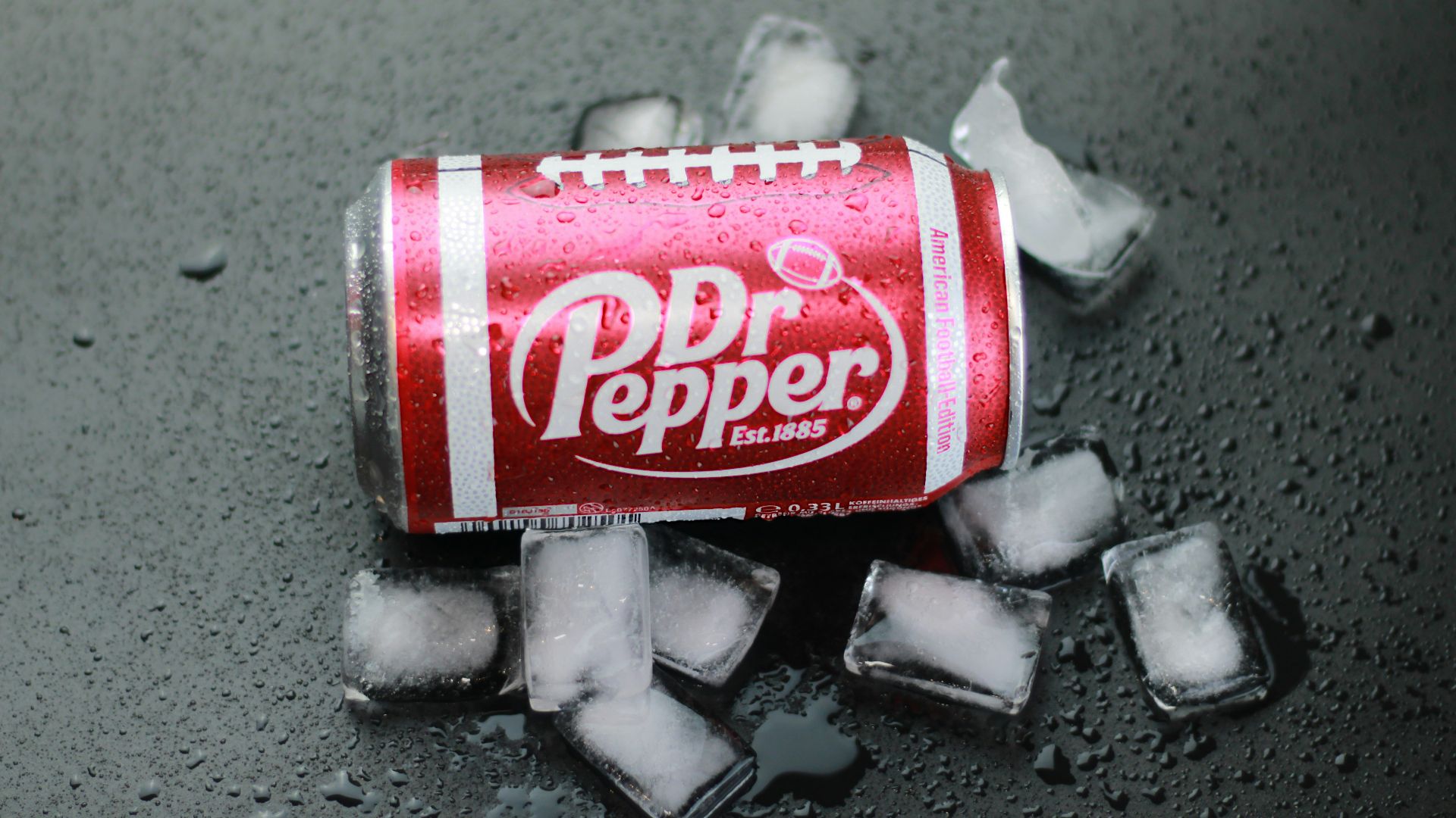 a can of soda sitting on top of ice cubes