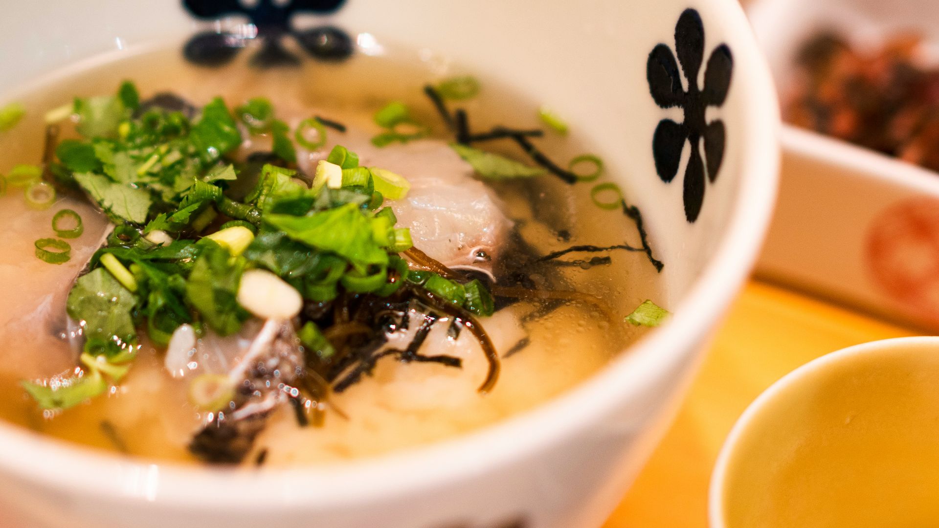 white and blue ceramic bowl with soup