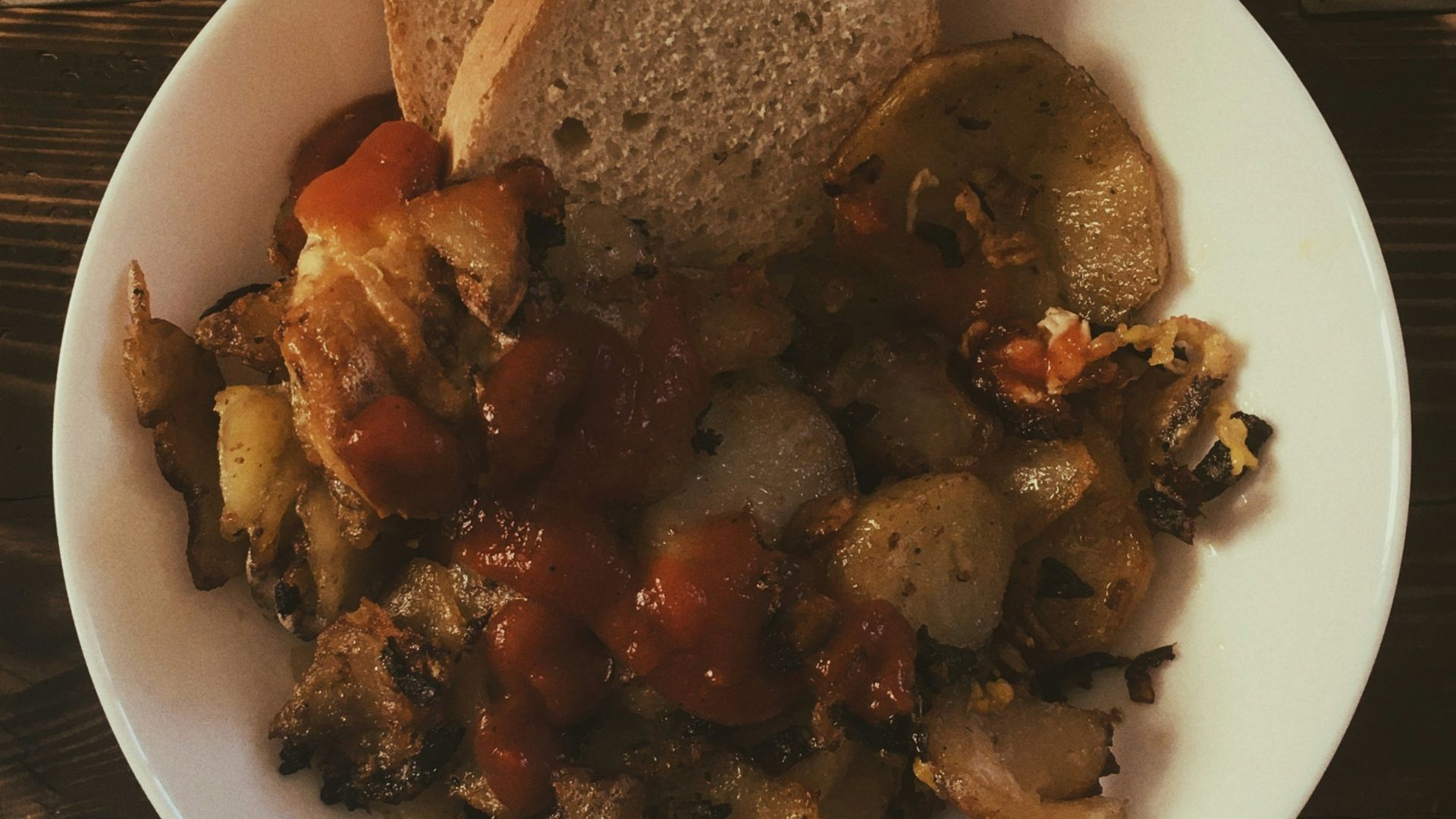 a white plate topped with bread and vegetables