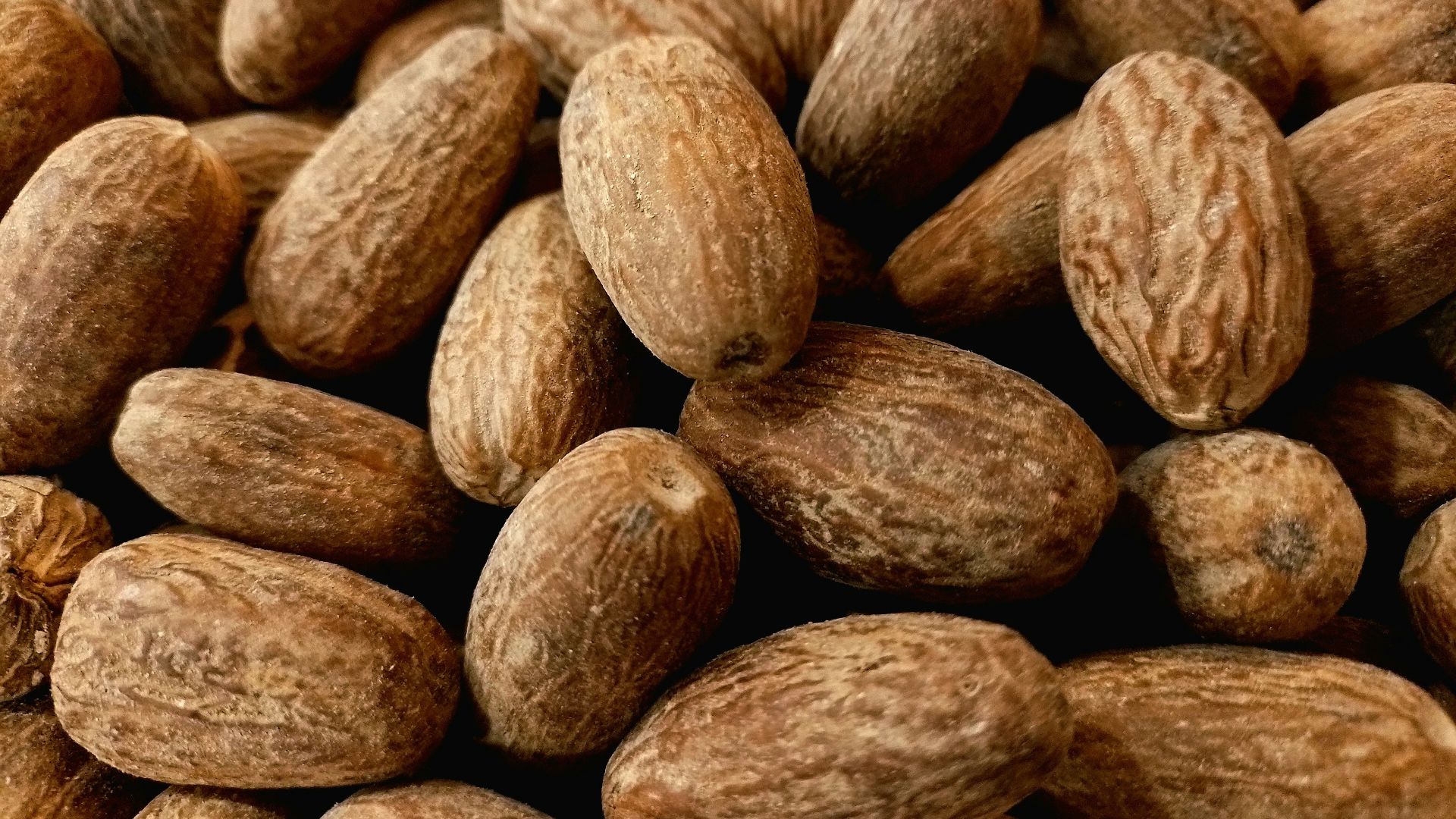 a pile of almonds sitting next to each other
