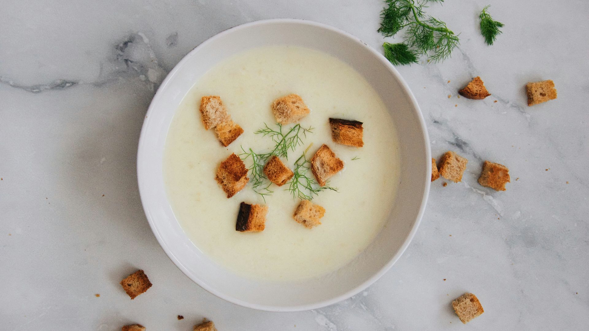soup with green leaf on white ceramic bowl