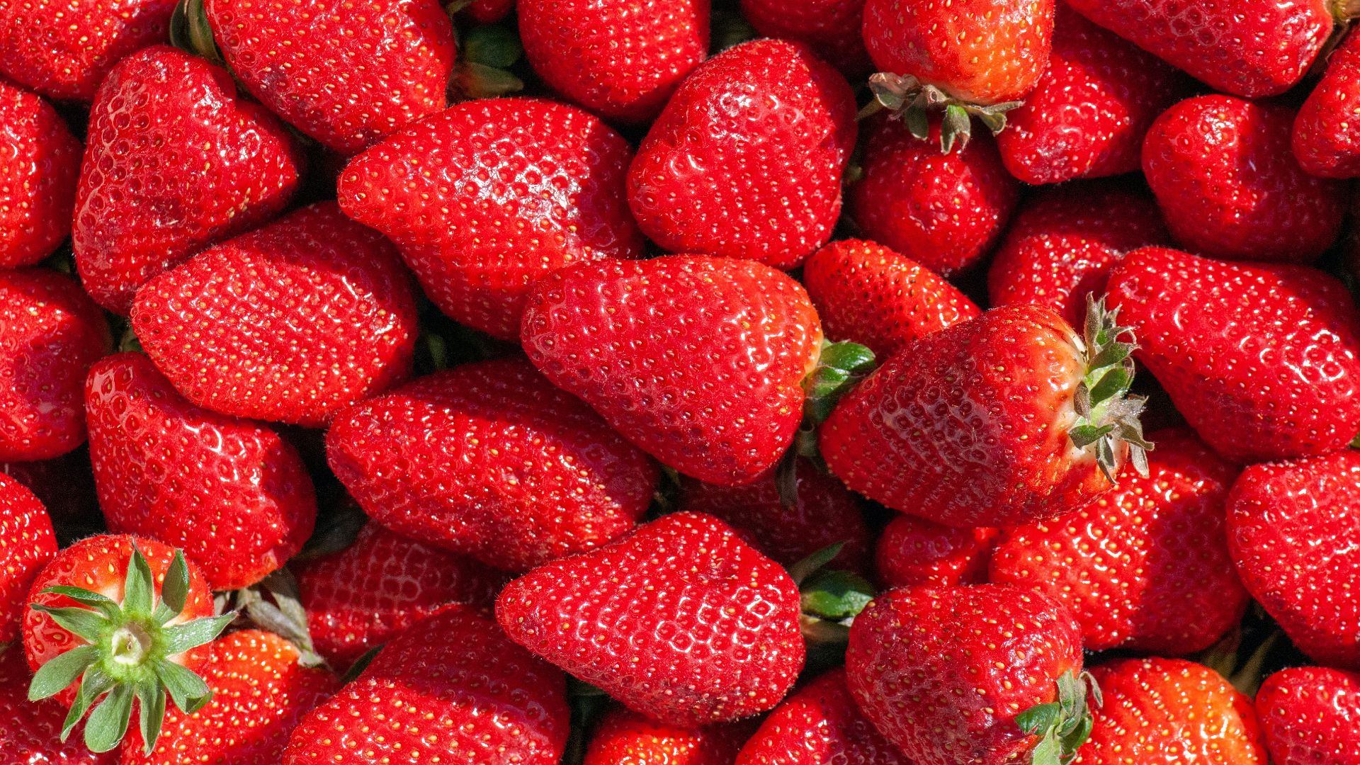 red strawberries on green leaves