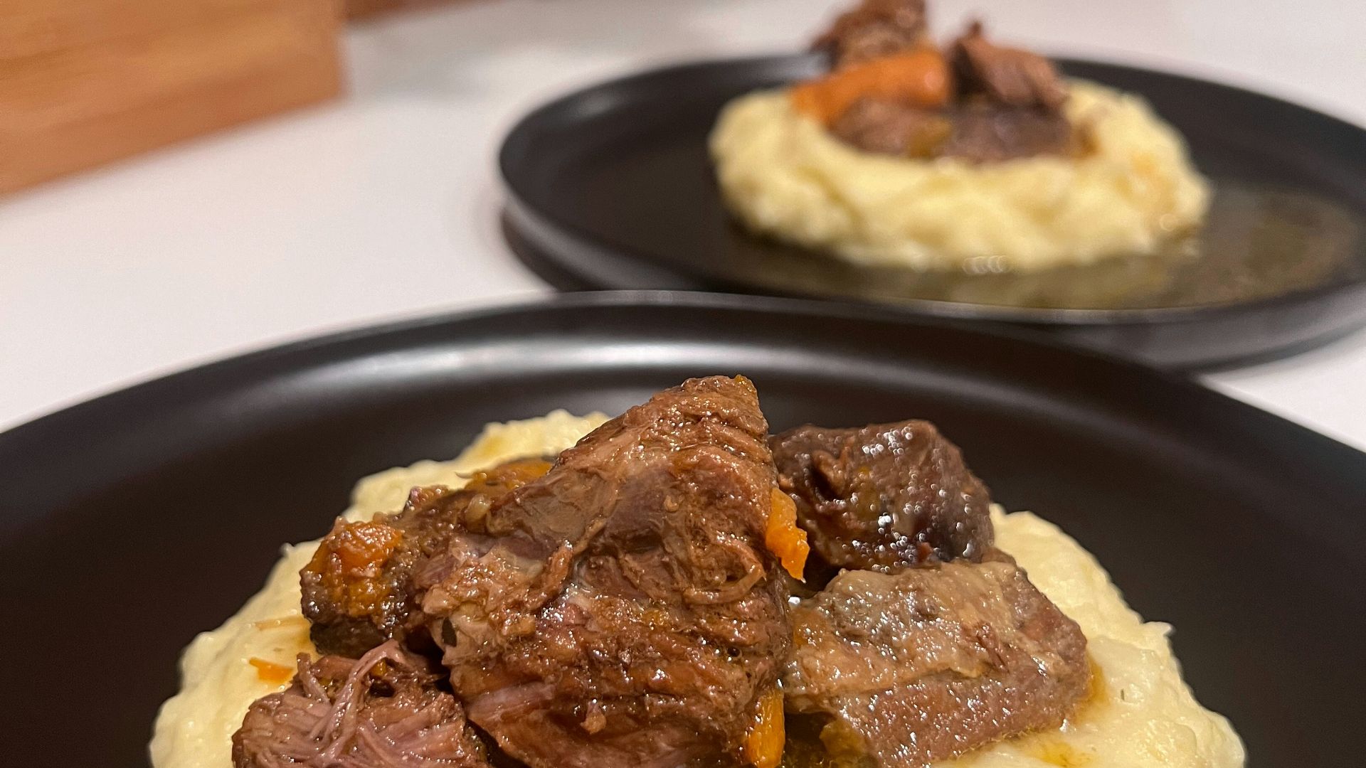 A plate of mashed potatoes with beef and gravy