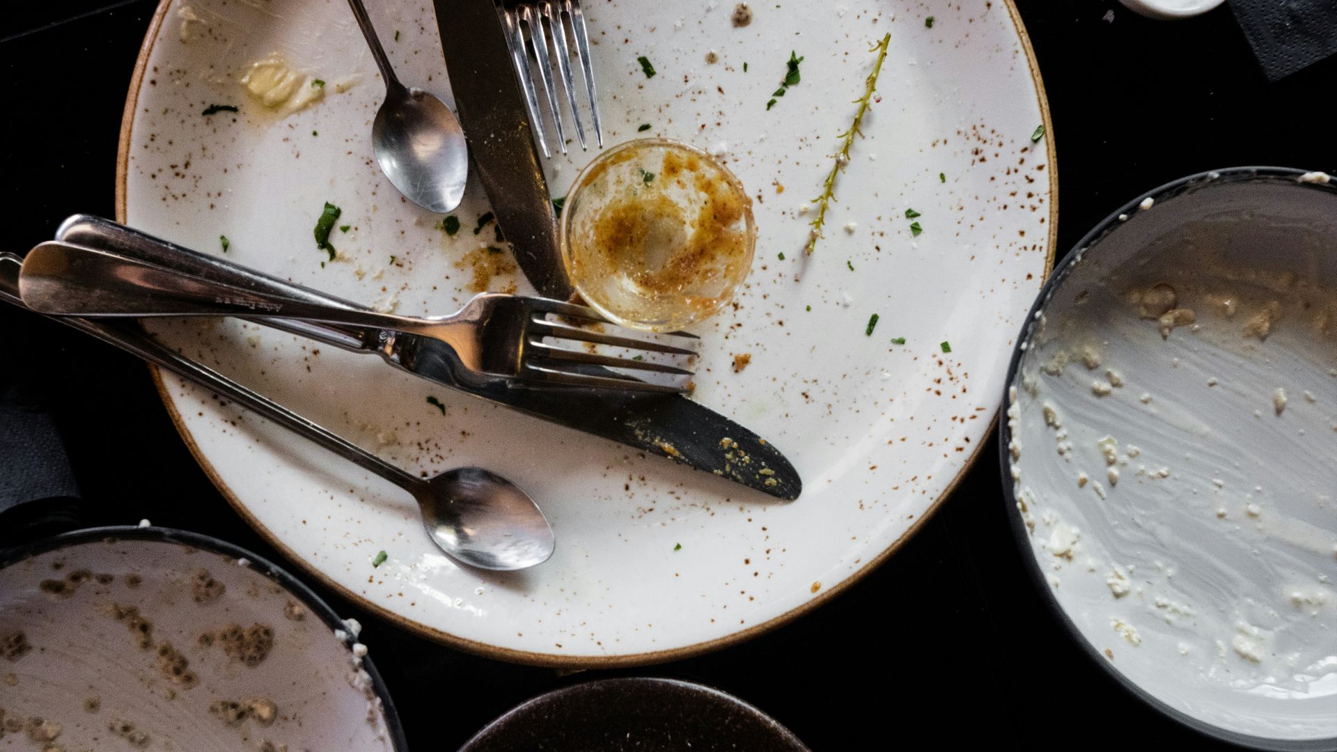 gray stainless steel fork and spoon on white ceramic plate