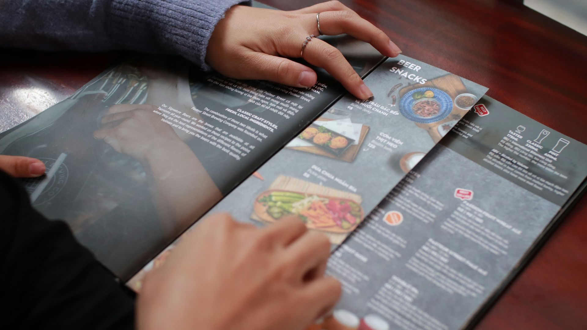 person holding white and black labeled box