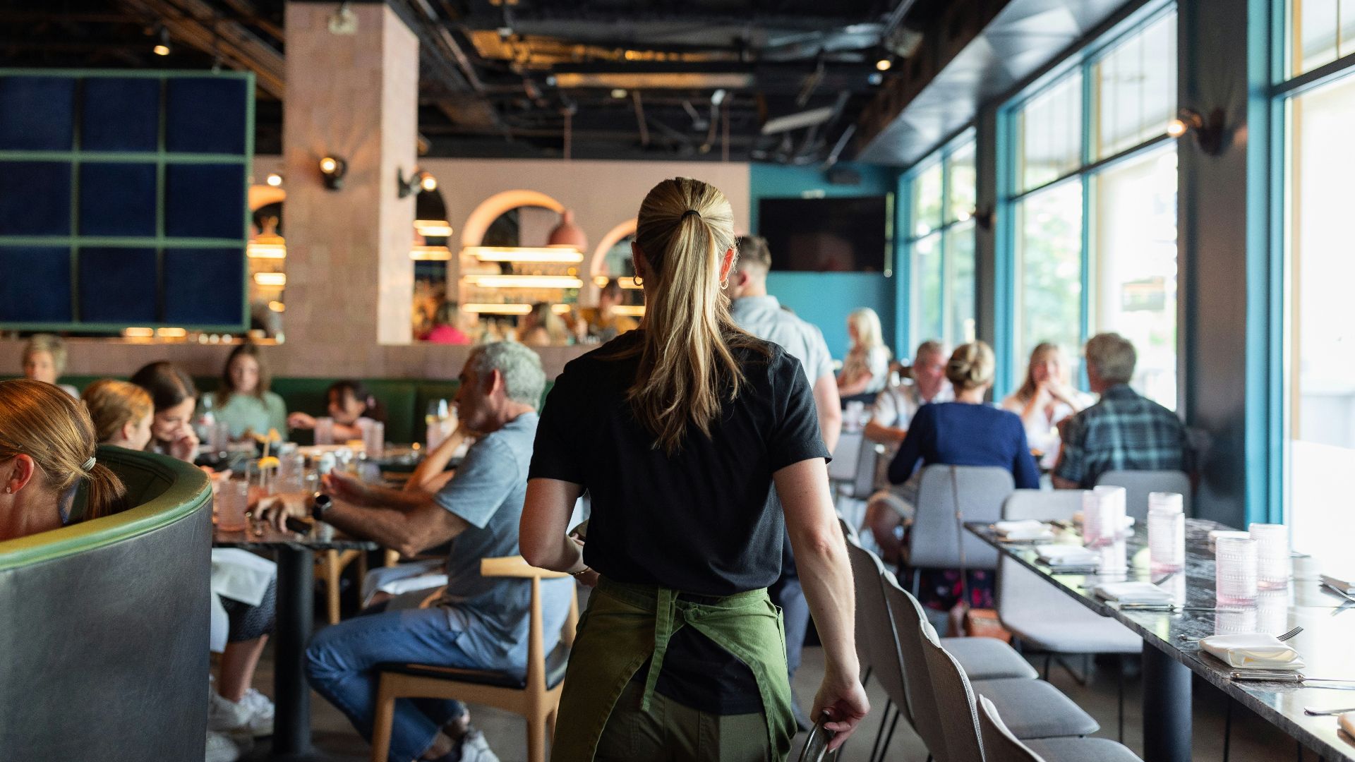 A group of people sitting at tables in a restaurant