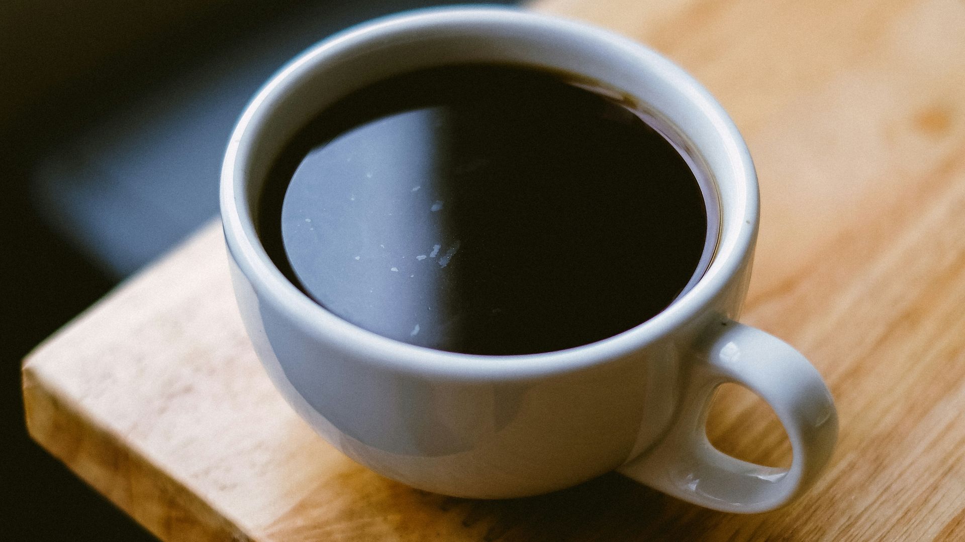white coffee cup on brown wooden table