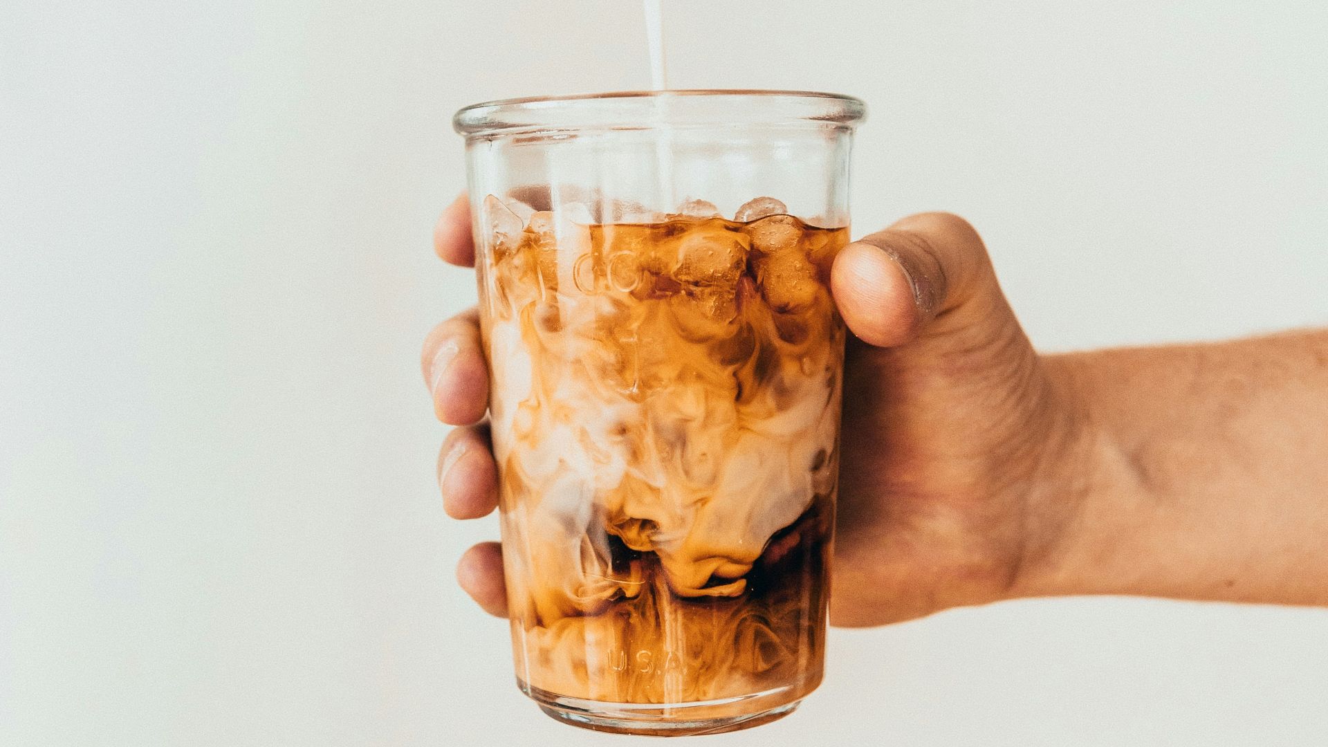 clear drinking glass with brown liquid