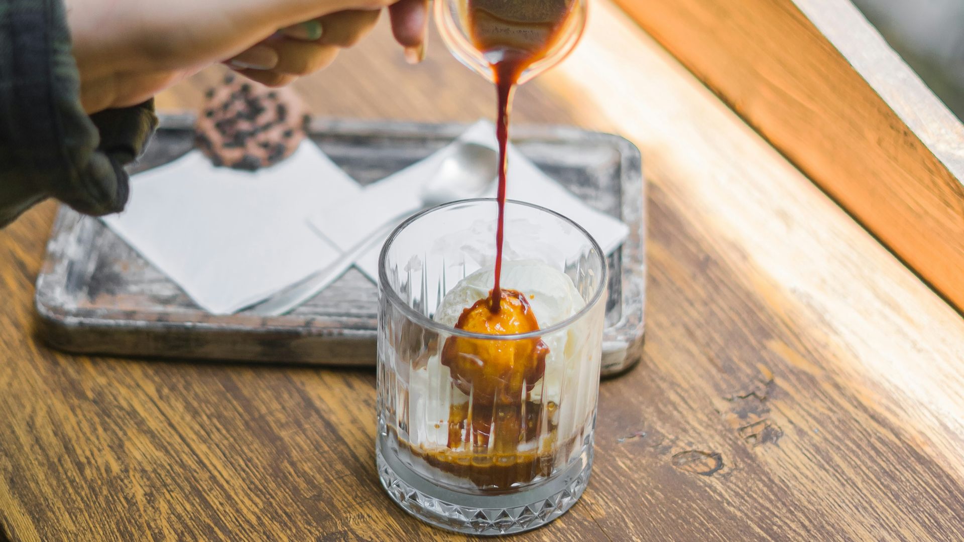 a hand pouring a glass of wine